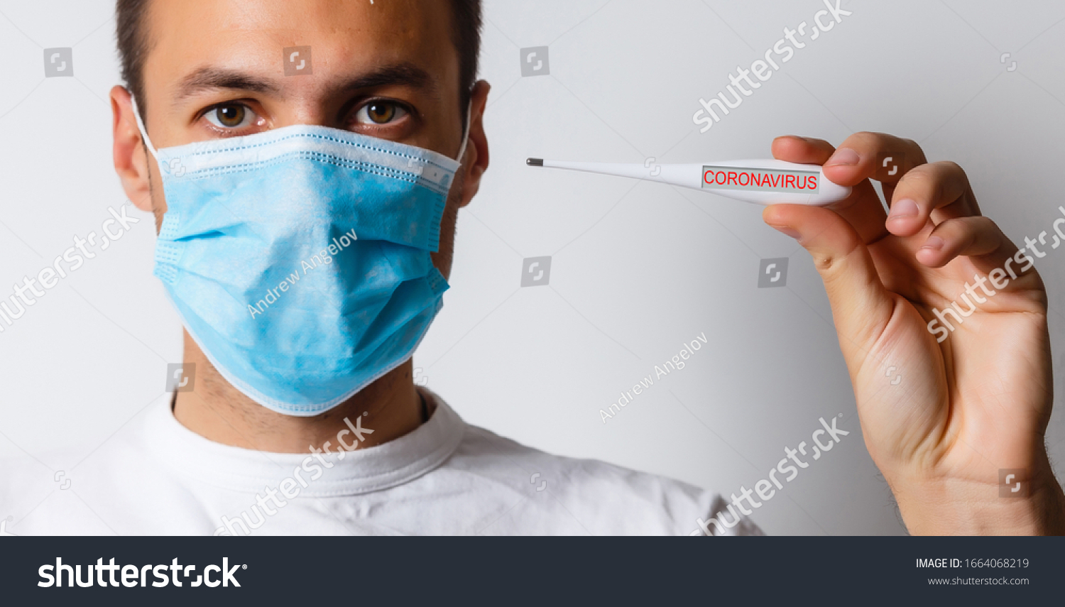 Coronavirus. 2019 Novel Coronavirus (2019-nCoV), Wuhan, China. A man with Coronavirus reads his temperature on a thermometer. Isolated on white. Room for text. Clipping Path. #1664068219