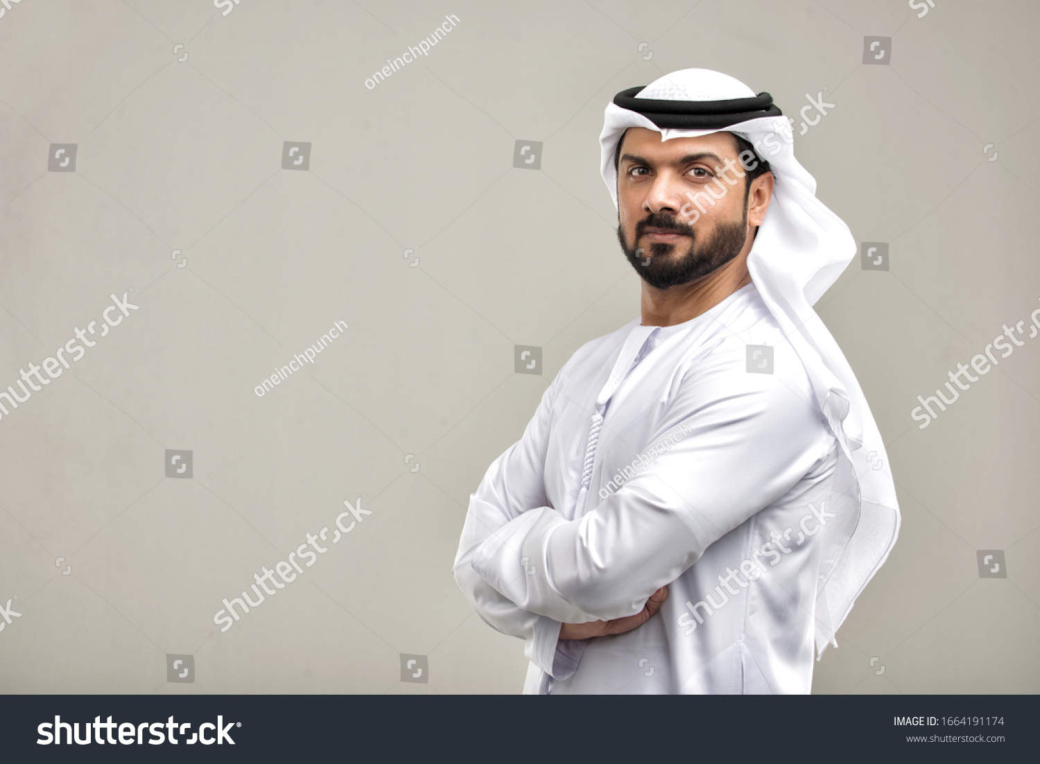 Portrait of arabic man with kandora in a studio #1664191174
