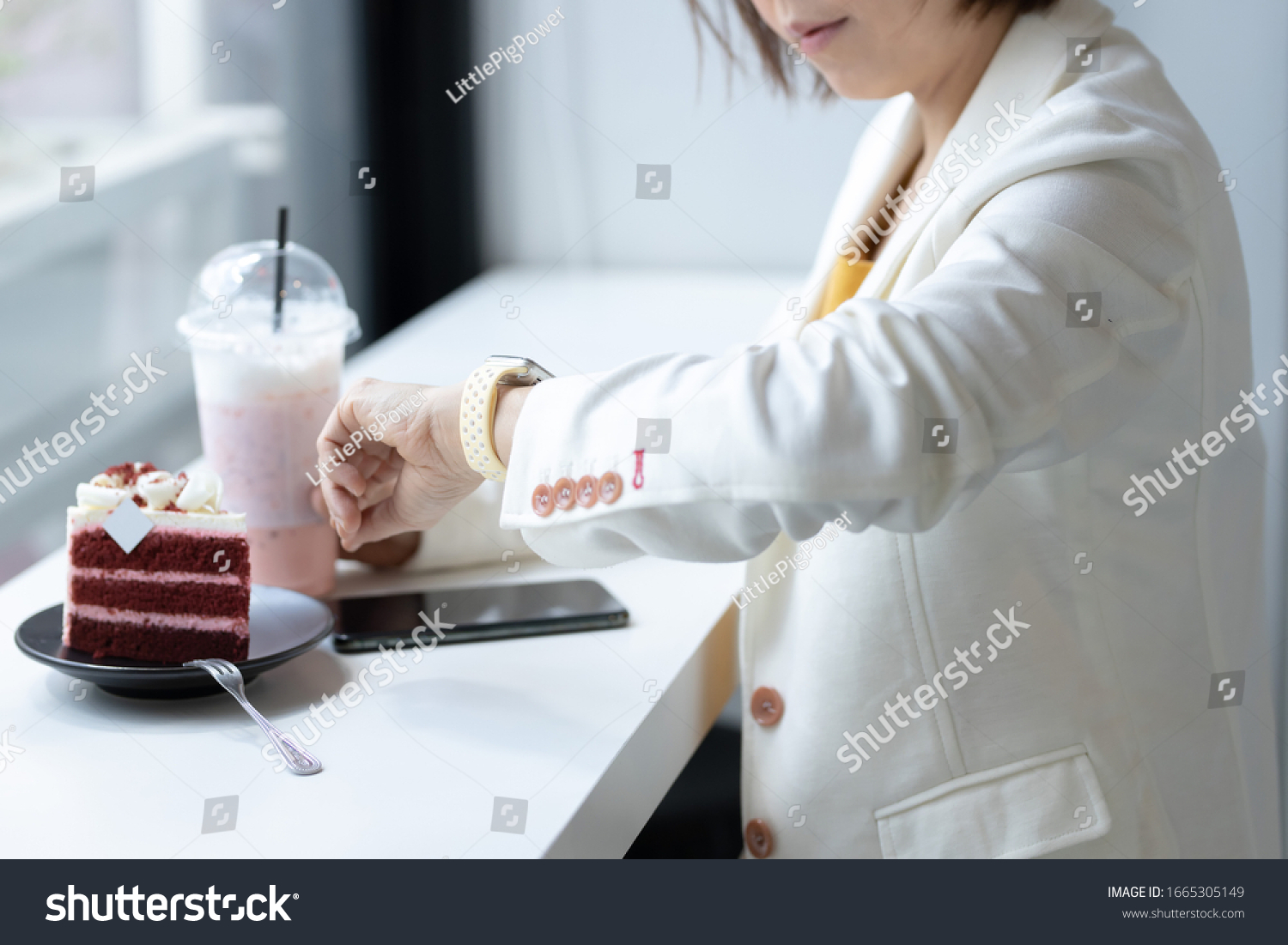 female look smartwatch to managing time for next meeting sitting at cafe resting in cozy cafeteria interior #1665305149