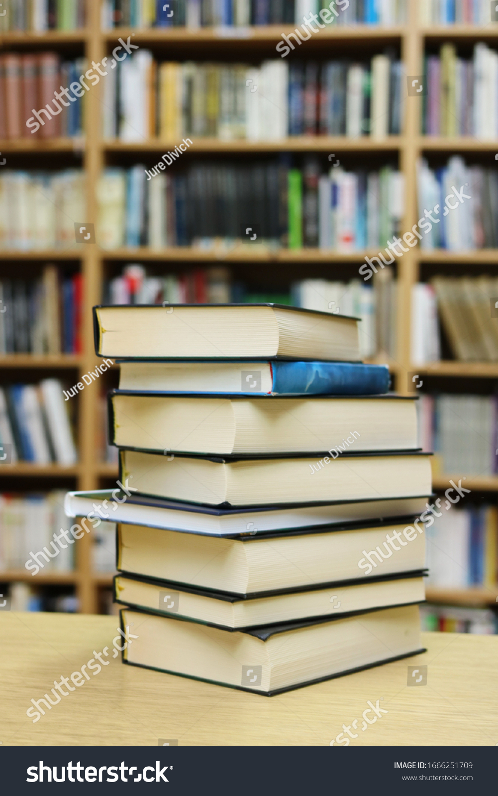 Stack of Books on the table in library
 #1666251709