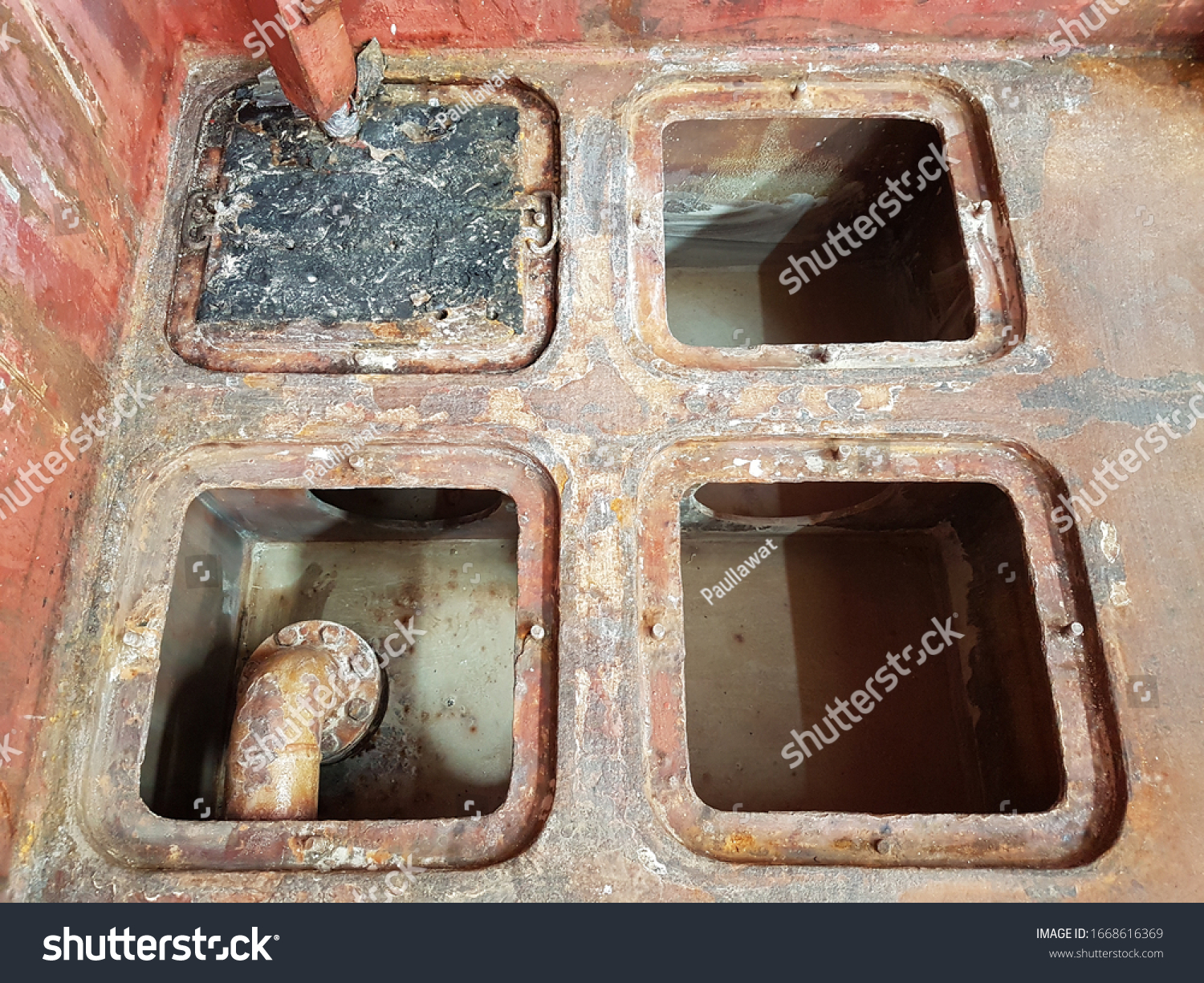 cargo hold bilge wells on bulk carrier after cleaning and preparing to list next cargo as per charter party. these wells will collect water from cargo and can be pumped out to prevent the damage. #1668616369