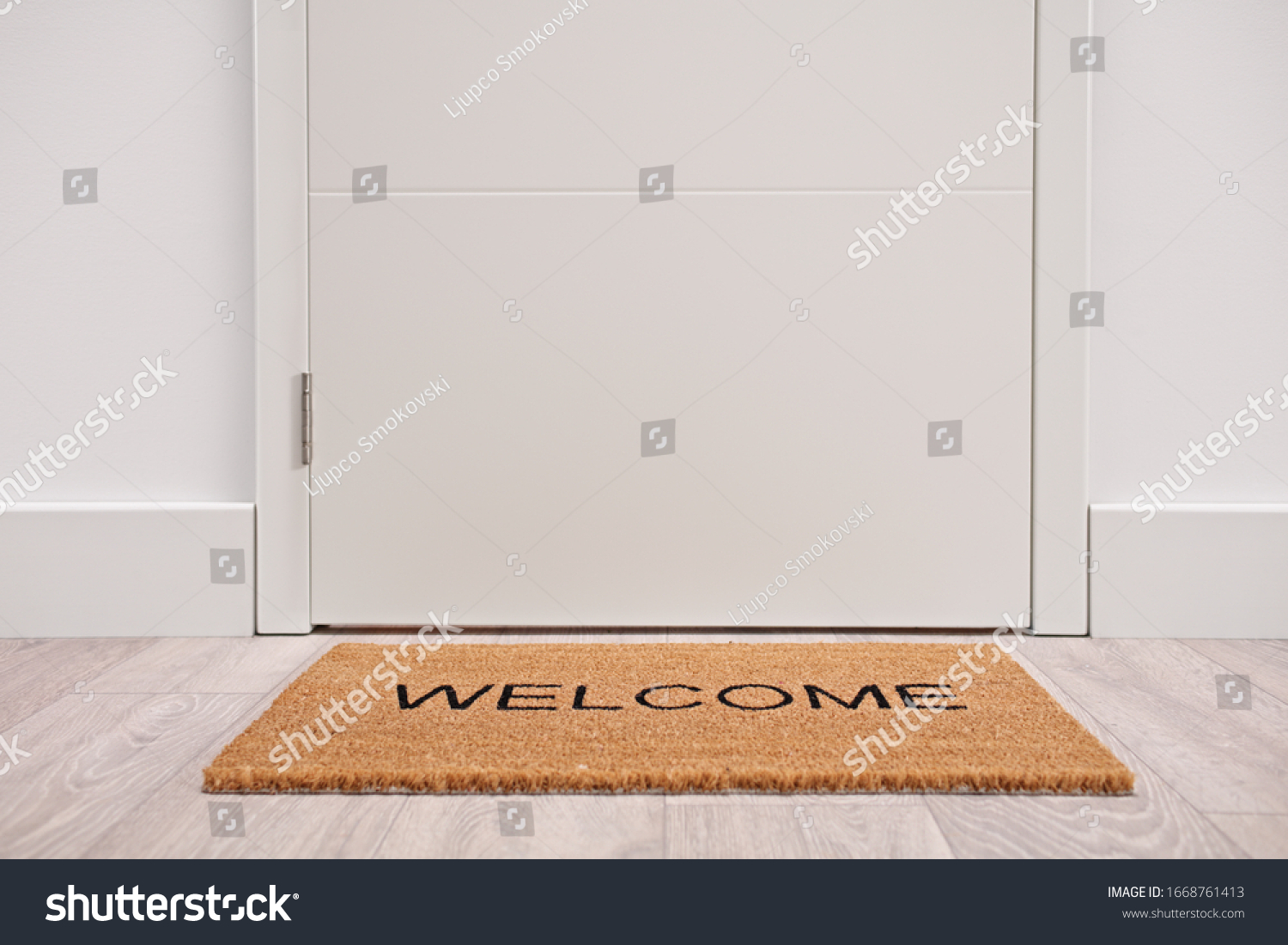 White door with a welcome mat #1668761413