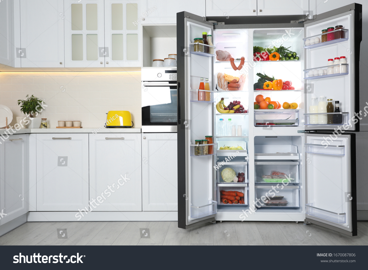 Open refrigerator filled with food in kitchen #1670087806