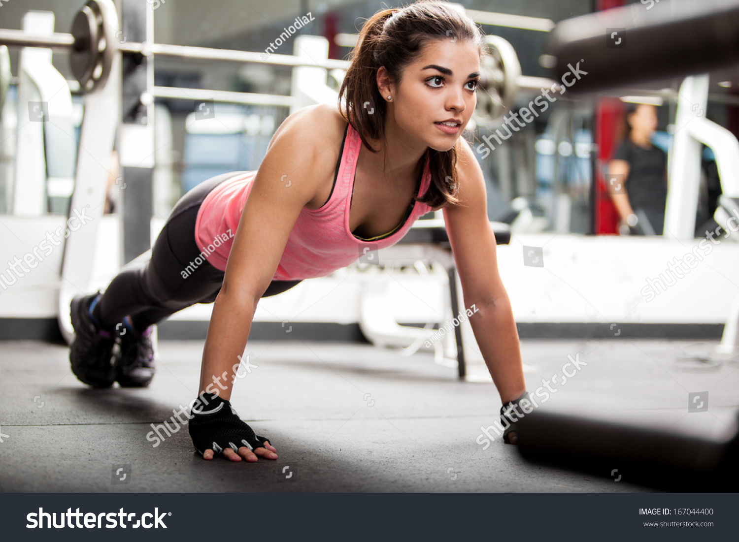 Gorgeous brunette warming up and doing some push ups a the gym #167044400