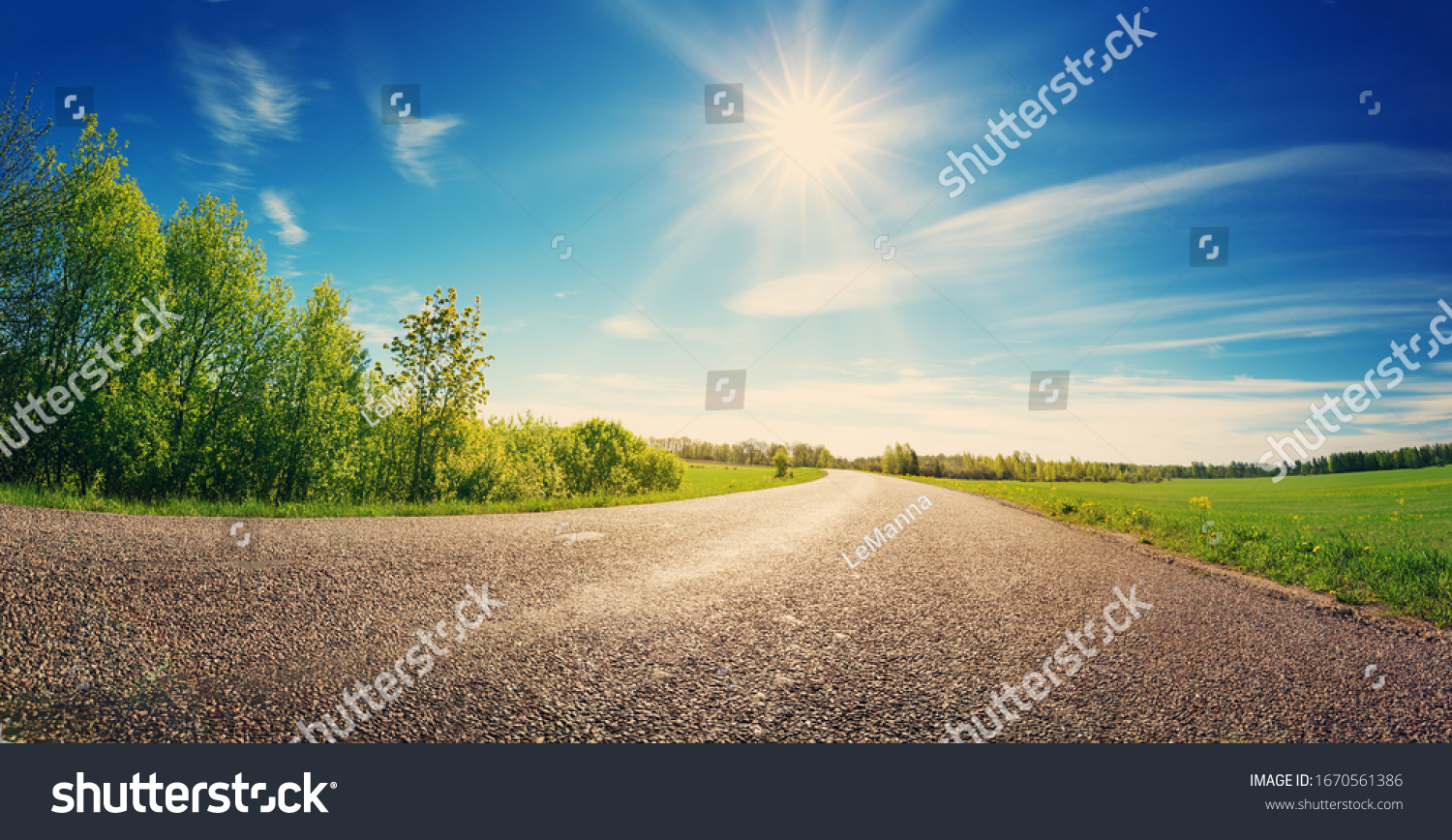 asphalt road panorama in countryside on sunny spring day #1670561386