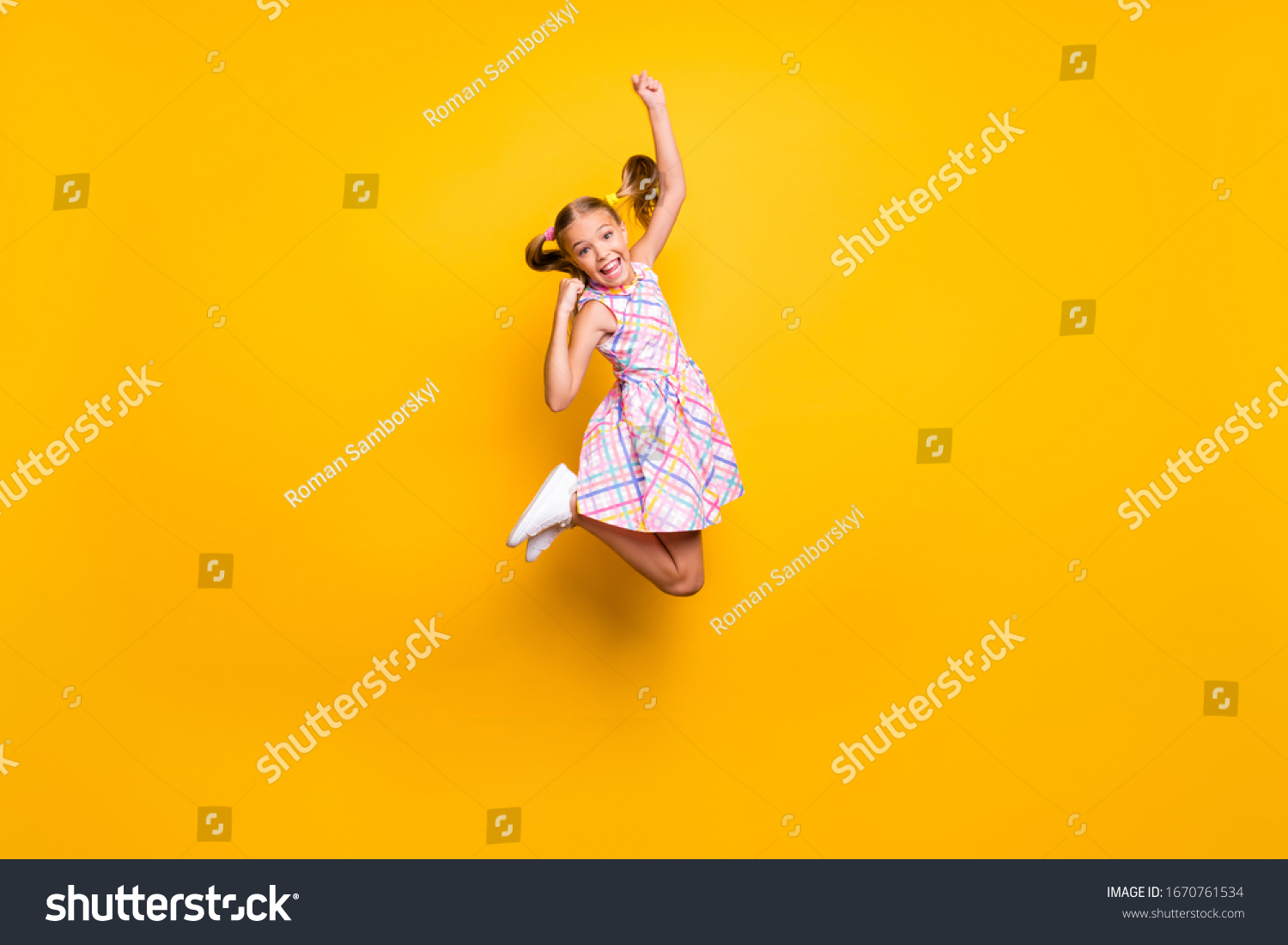 Full length photo of cheerful kid jump enjoy rejoice win lottery sales raise fists scream yeah wear checkered skirt isolated bright shine color background #1670761534