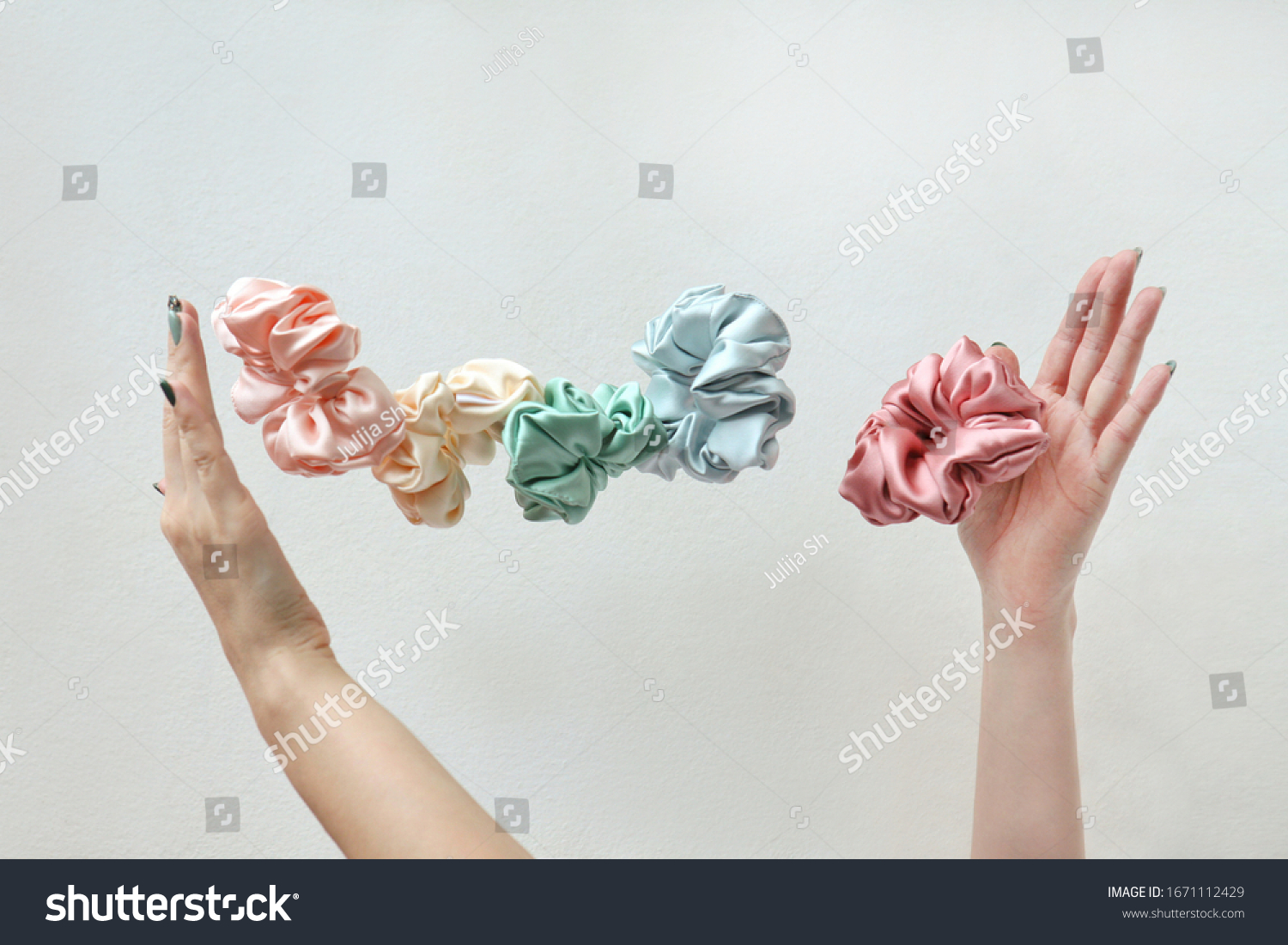 Lot of floating Colorful silk Scrunchies on womas hands isolated white. Hairdressing tools and accessories. Hair Scrunchies, Elastic HairBands, flying or falling Scrunchie Hairband for girl. copy #1671112429
