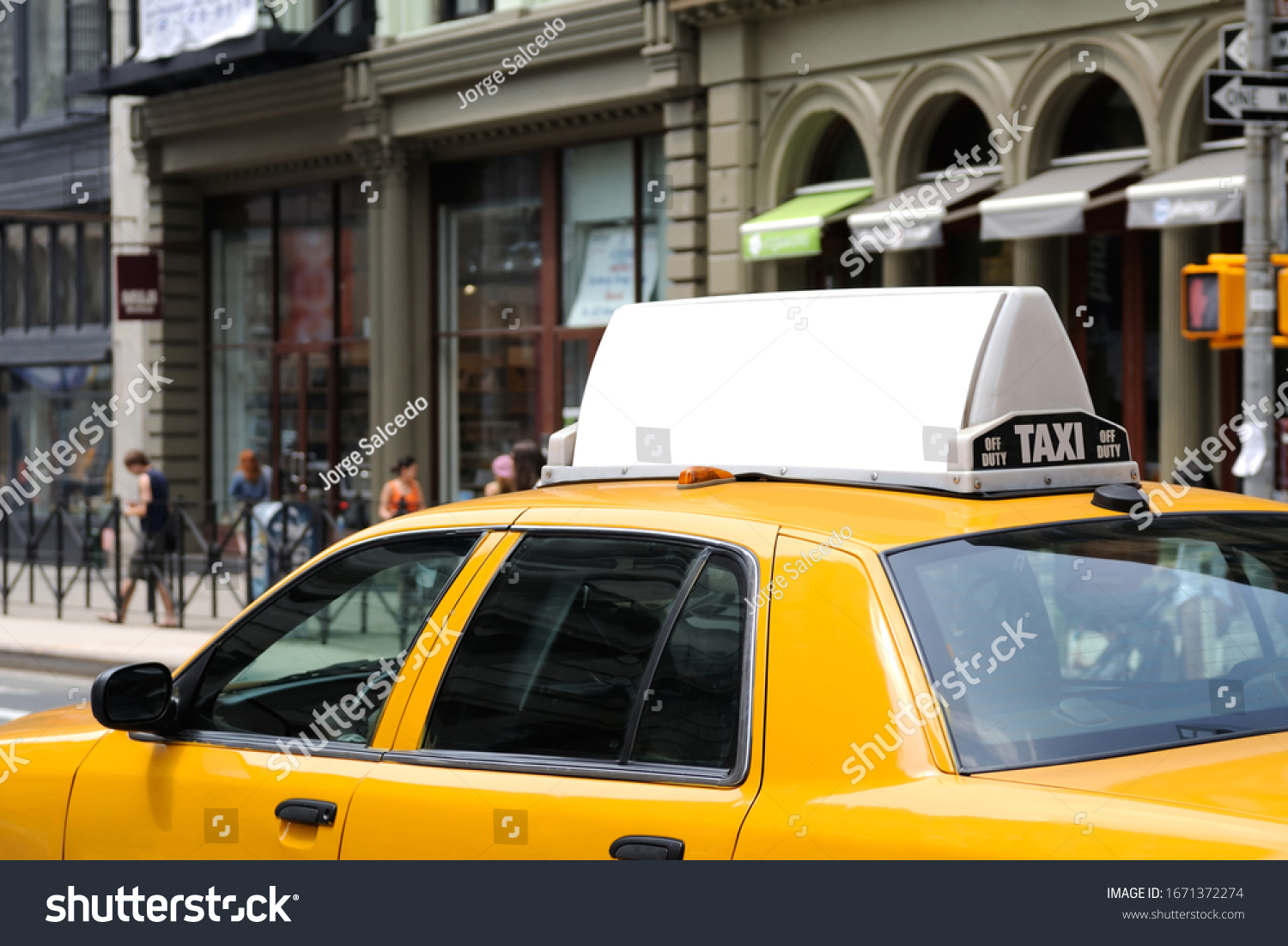 Taxi top advertising. Billboard display on yellow cab. #1671372274