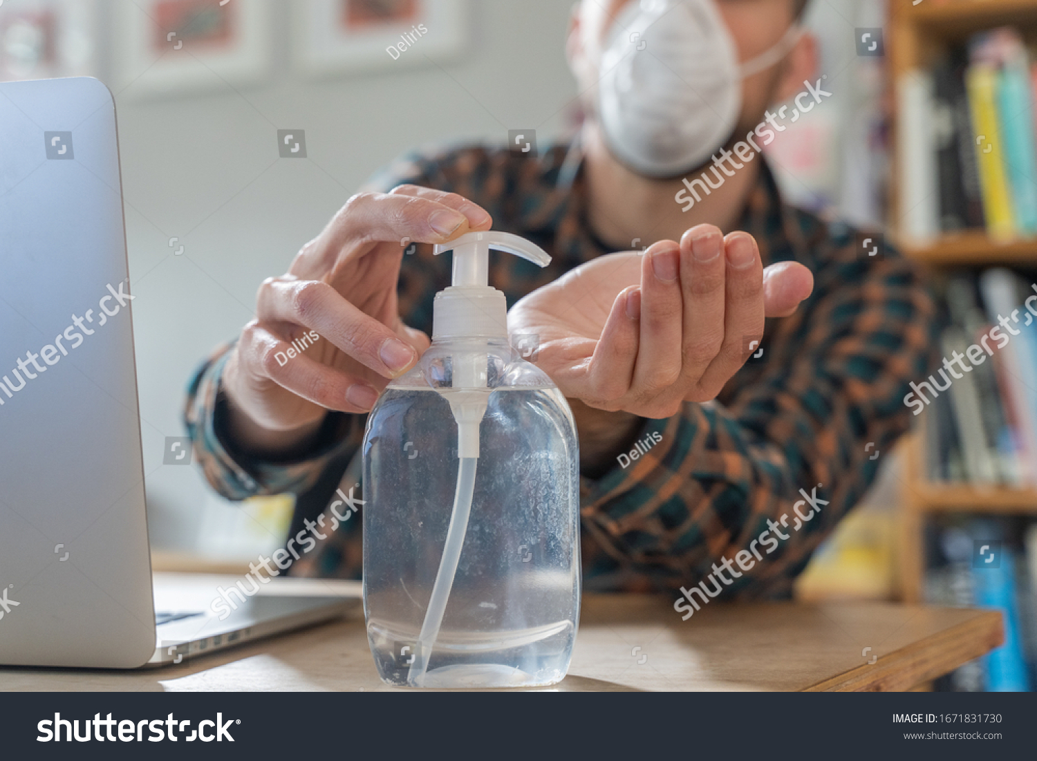 Coronavirus. Man working from home wearing protective mask. quarantine for coronavirus wearing protective mask. Working from home. Cleaning her hands with sanitizer gel.  Thermometer fever inspection. #1671831730