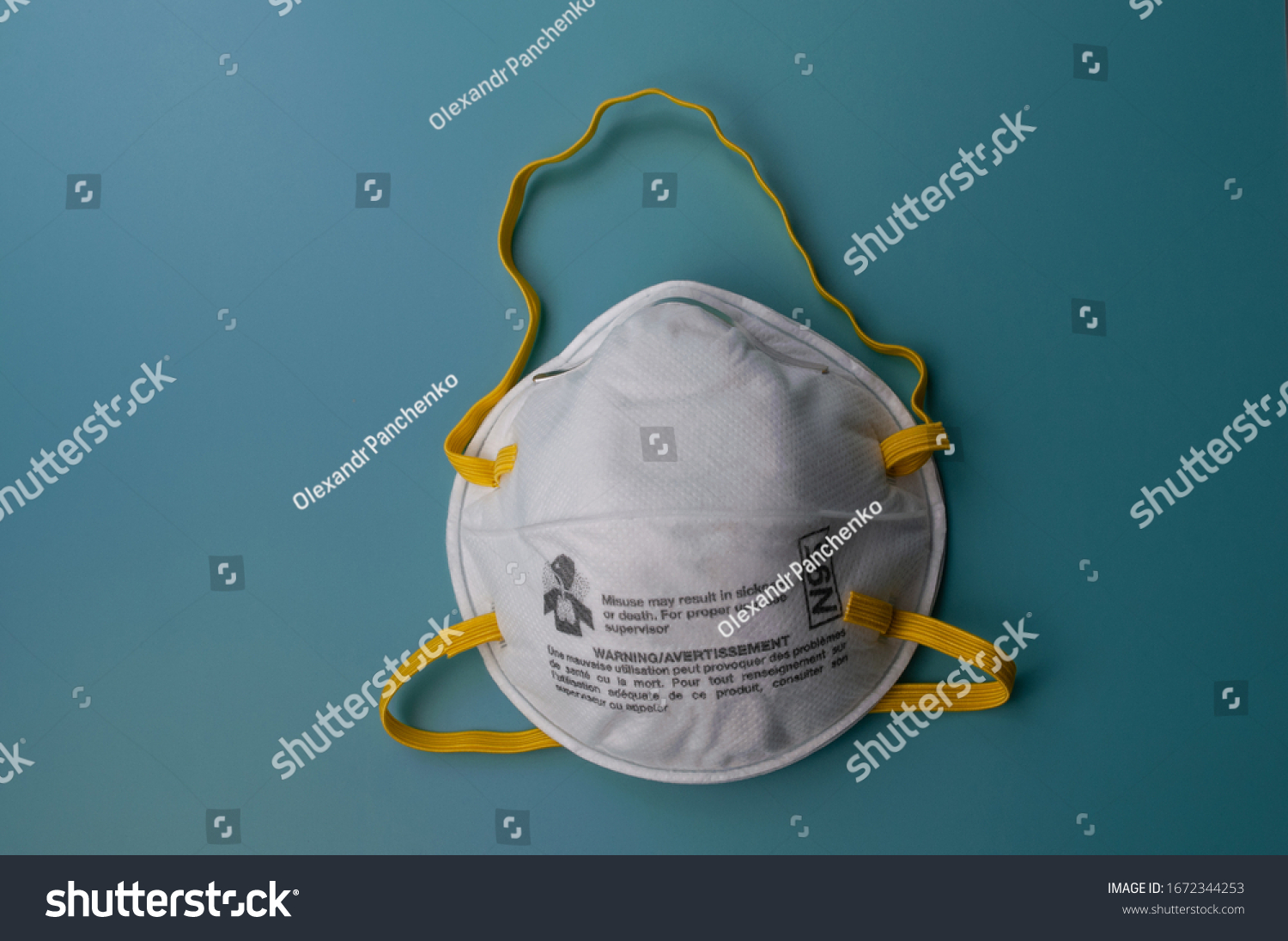 N95 respirators and surgical mask corona virus protection isolated on a blue background. Particulate Filtering Facepiece Respirators #1672344253