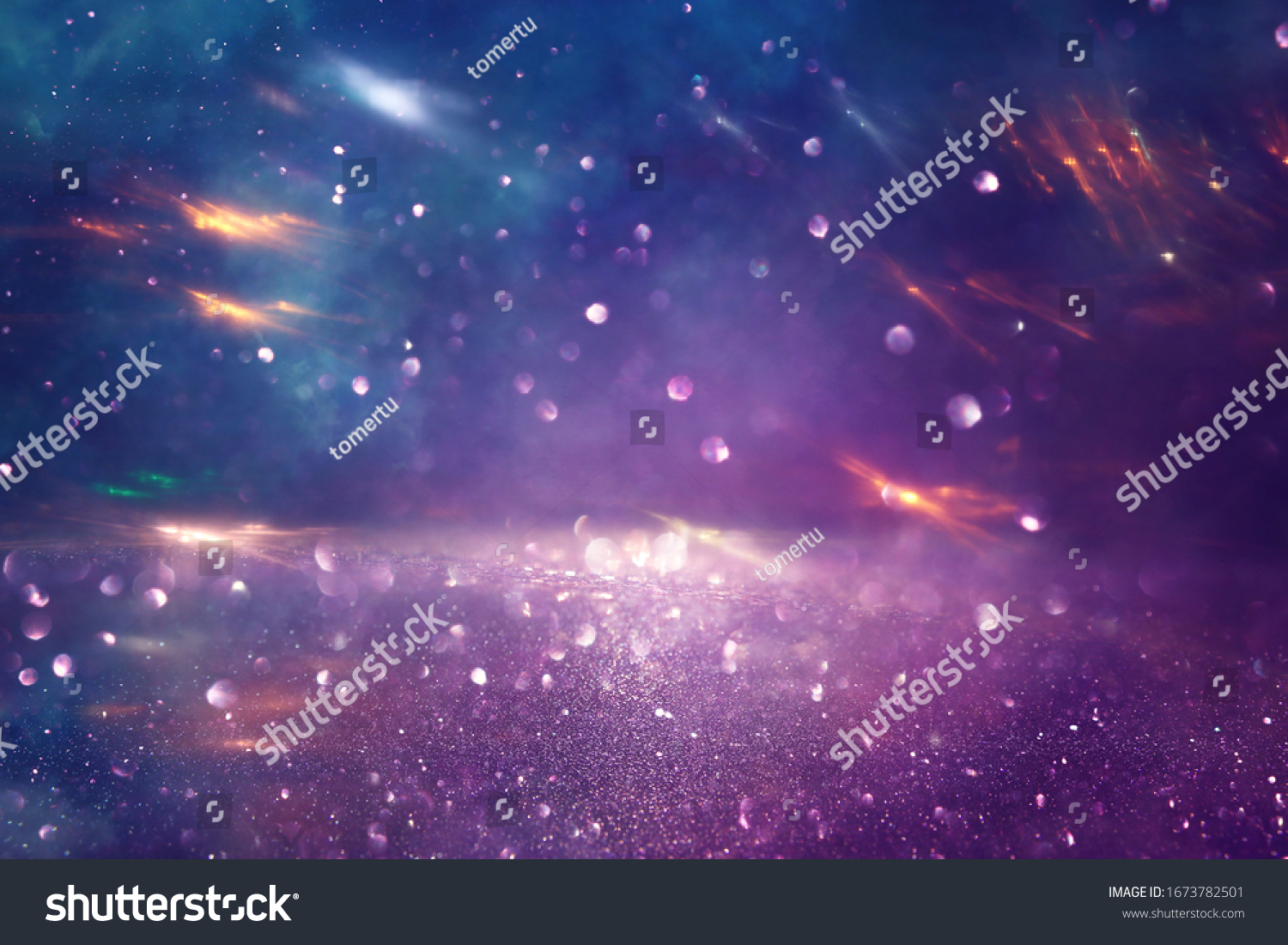background of abstract glitter lights. gold, blue and purple. de focused #1673782501