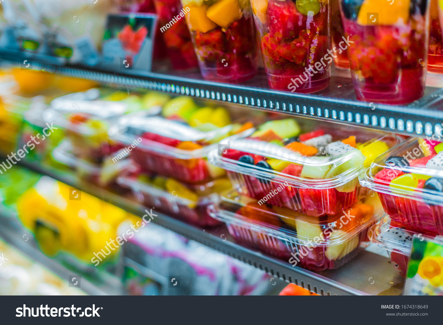 Packages with fresh fruits displayed in a commercial refrigerator #1674318649