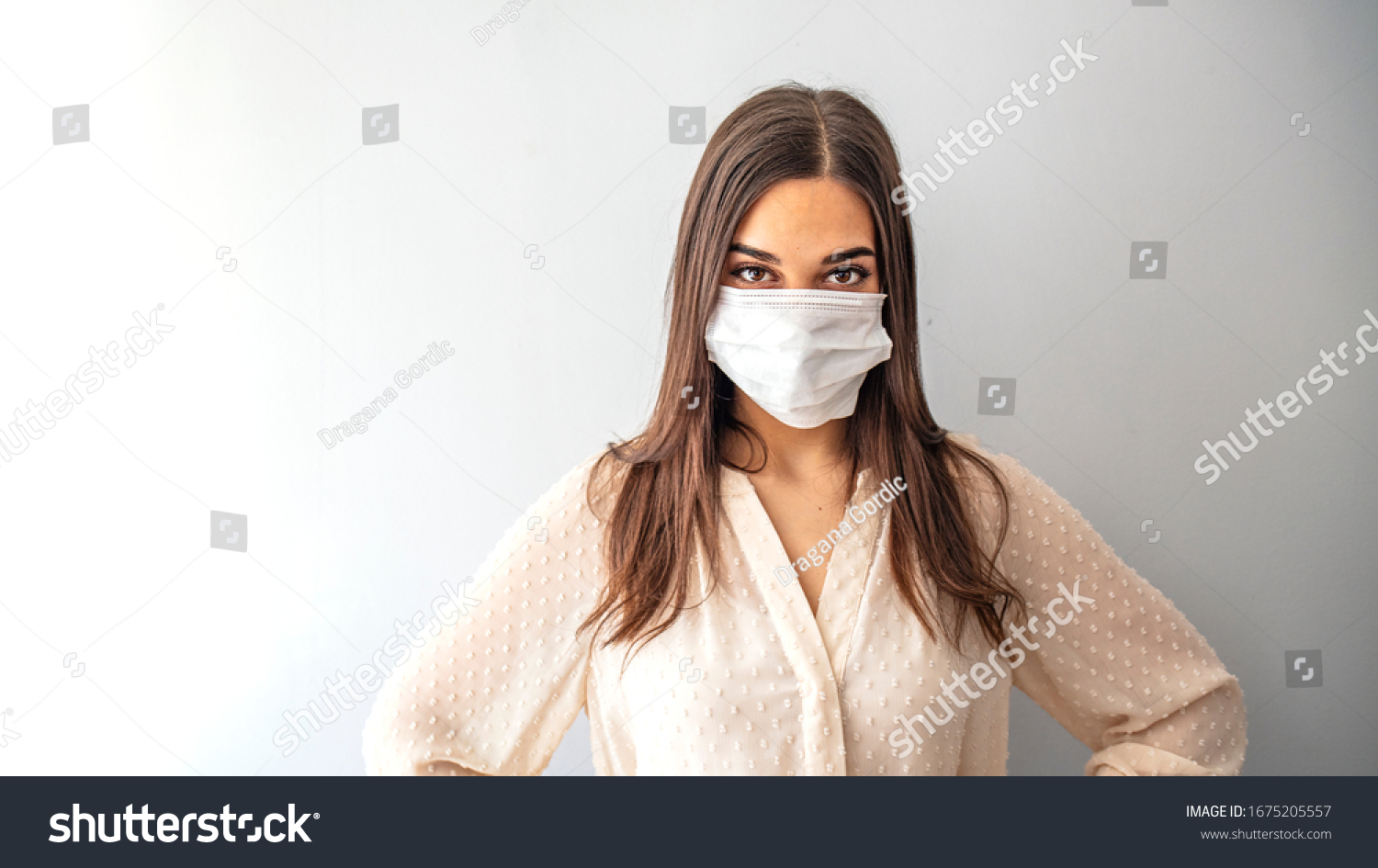Girl in respiratory mask. Masked woman looks at camera. Cold, flu, virus, tonsillitis, respiratory disease, quarantine, epidemic concept. Beautiful caucasian young woman with disposable face mask #1675205557