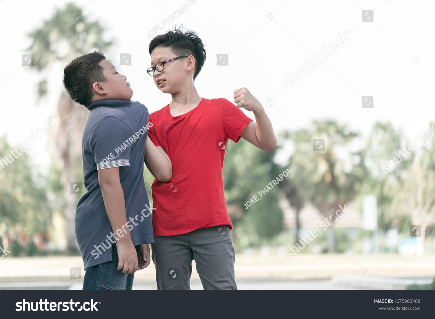 Asian Boy student getting bullied in school. Children bullying their classmate in playground.Violence, Banner and problem of bullying concept #1675963468