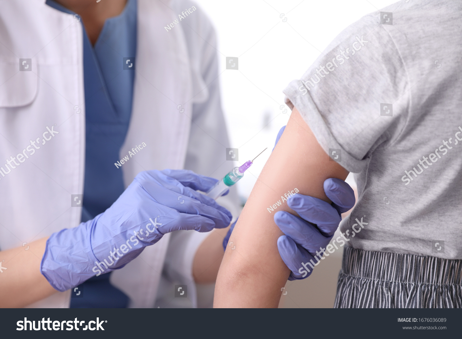 Little girl receiving chickenpox vaccination in clinic, closeup. Varicella virus prevention #1676036089