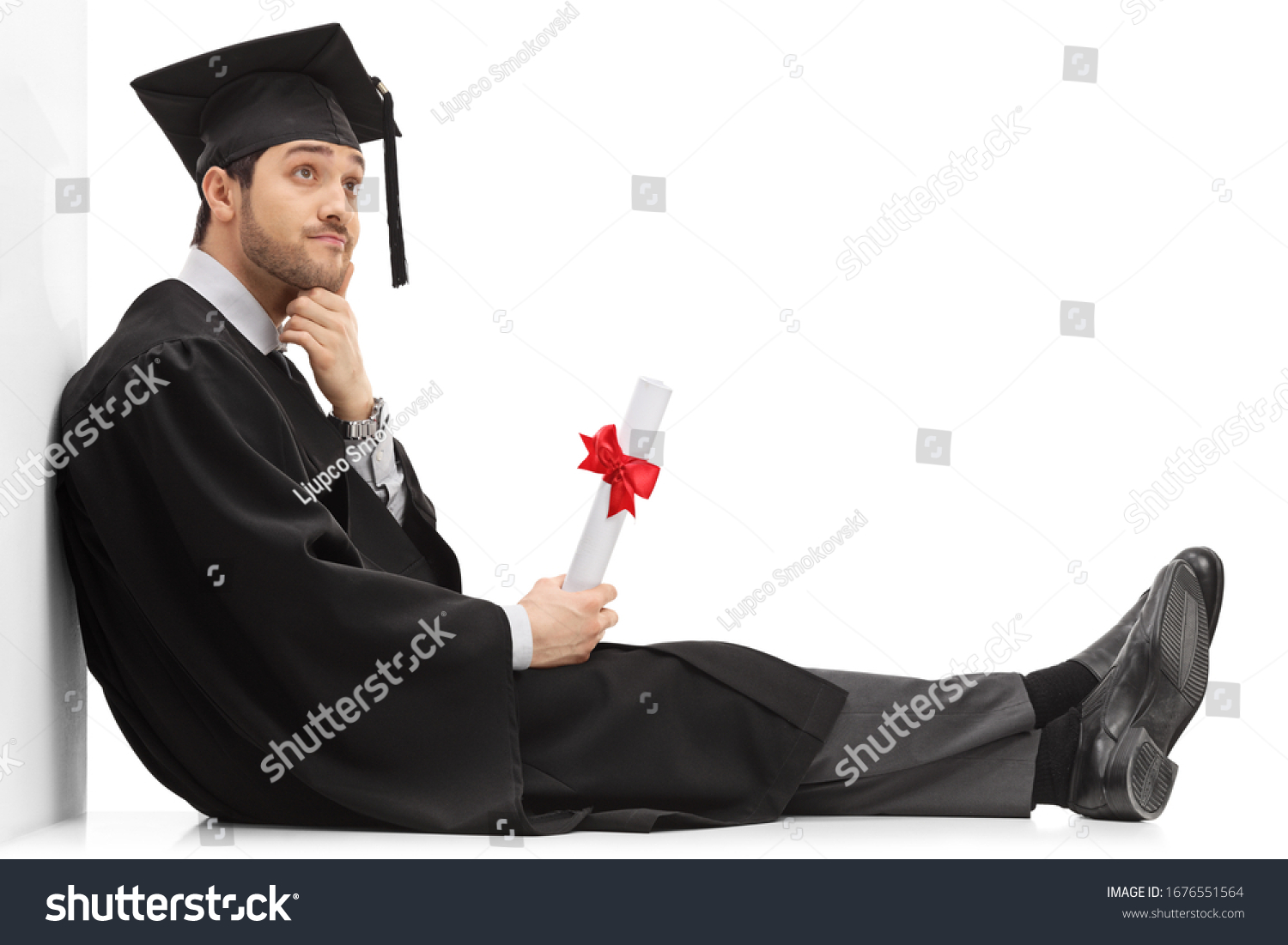 Pensive graduate male student holding a diploma - Royalty Free Stock ...