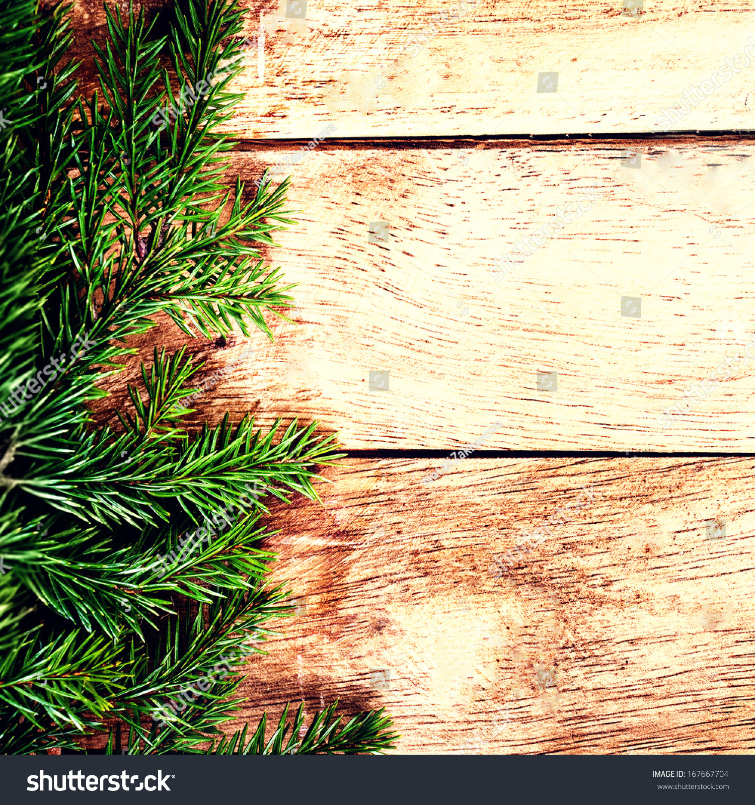Christmas background with Fir Tree Branch over wood wall. Vintage Christmas Card with copyspace for greeting text. #167667704