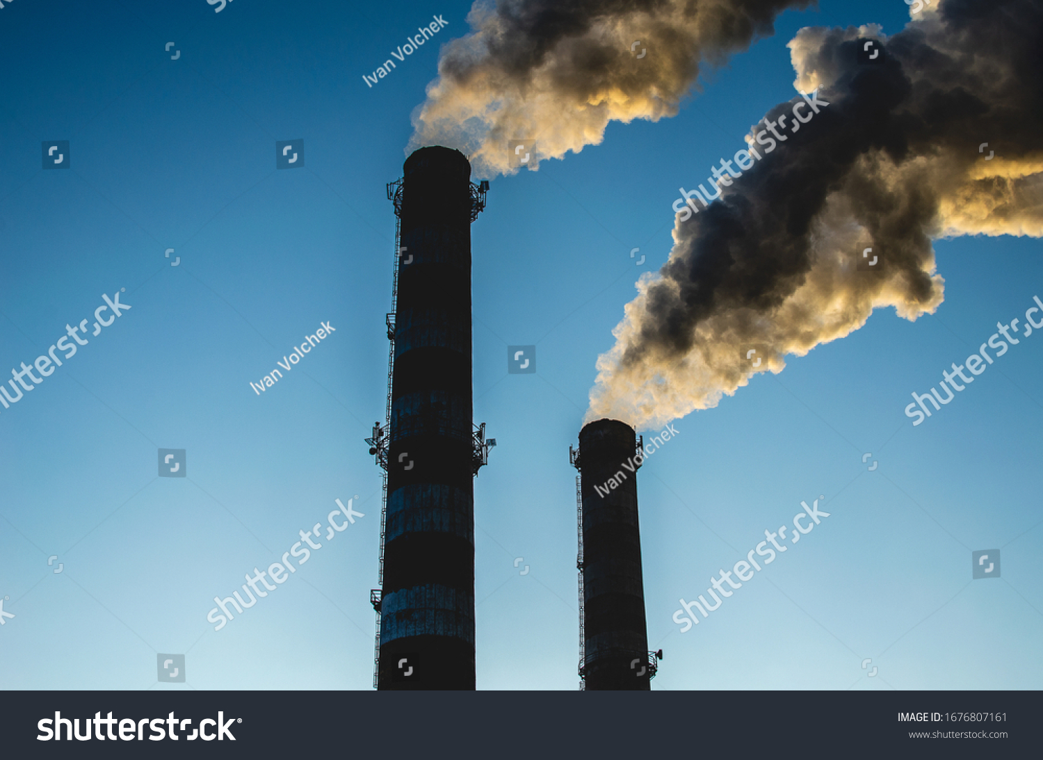 Exhaust fumes blown into a sky. Smoke from industrial chimneys against a blue sky. Smoke from factory chimneys in an urban environment. Concept: environmental pollution, ecology #1676807161