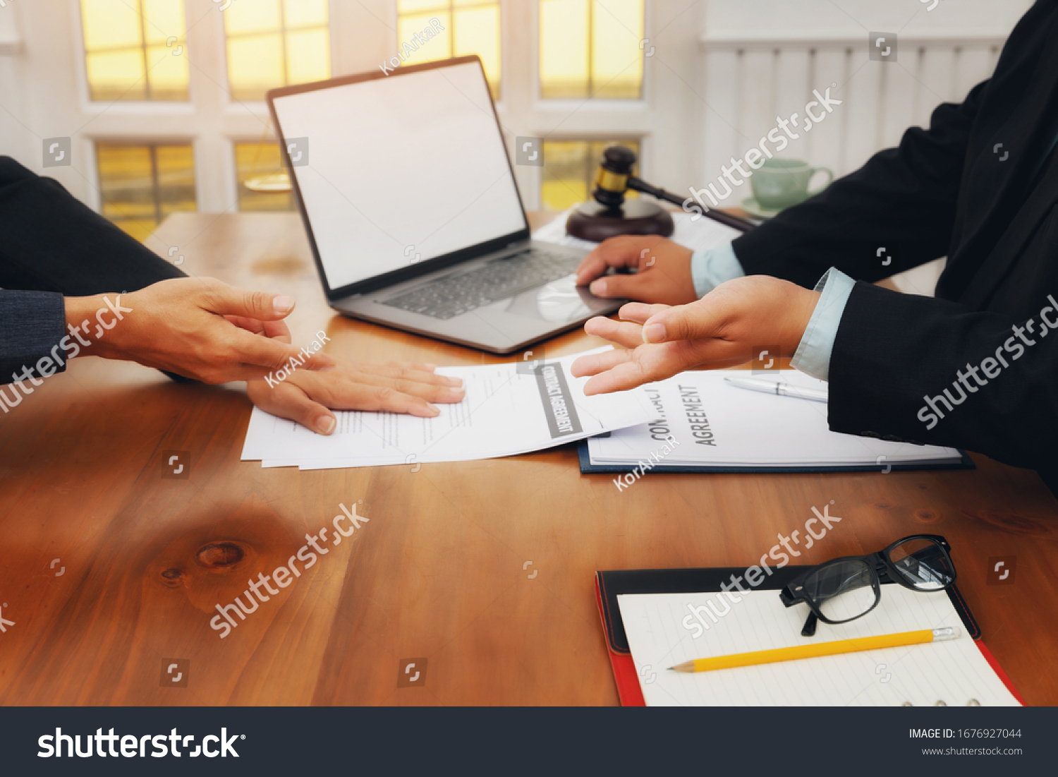 The lawyer submits a contract document to the client at table in office. Sign a contract business. Treaty of the law. #1676927044