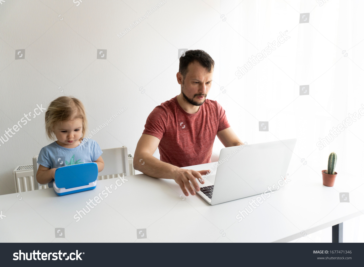 Young caucasian man, father should work from home during quarantine time at coronavirus. Child at home, kindergarden closed. Baby helps father to work. They work in laptops. White background. #1677471346