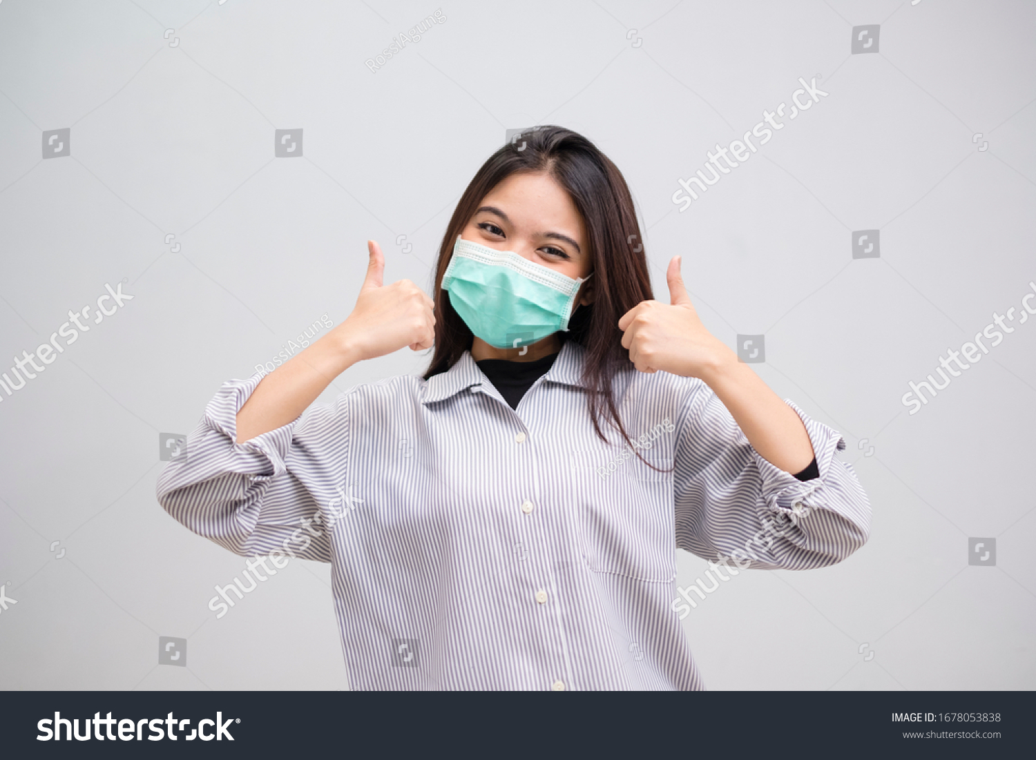 Portrait of a cheerful and healthy young woman asian wearing medical mask. Pandemic 2019 Coronavirus 2019-nCoV Concept. #1678053838