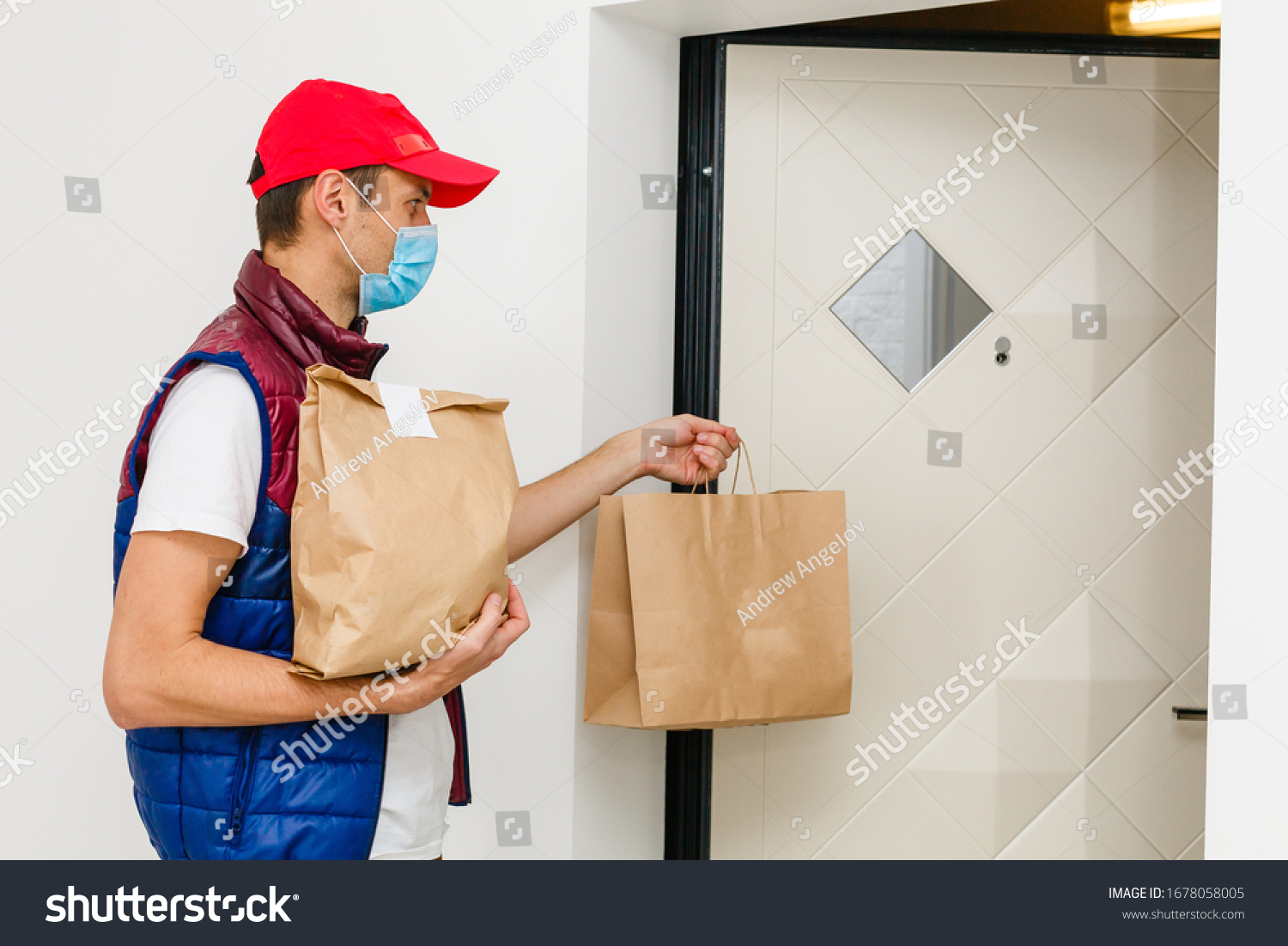 Delivery man holding paper bag with food on white background, food delivery man in protective mask #1678058005