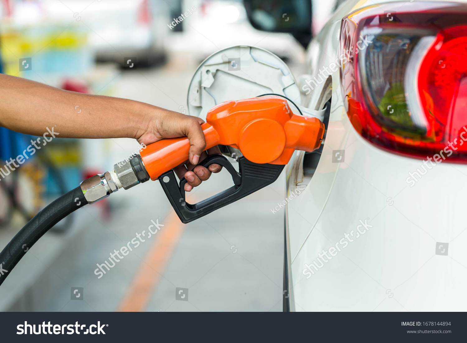 Man Refill and filling Oil Gas Fuel at station.Gas station - refueling.To fill the machine with fuel. Car fill with gasoline at a gas station. Gas station pump.  #1678144894