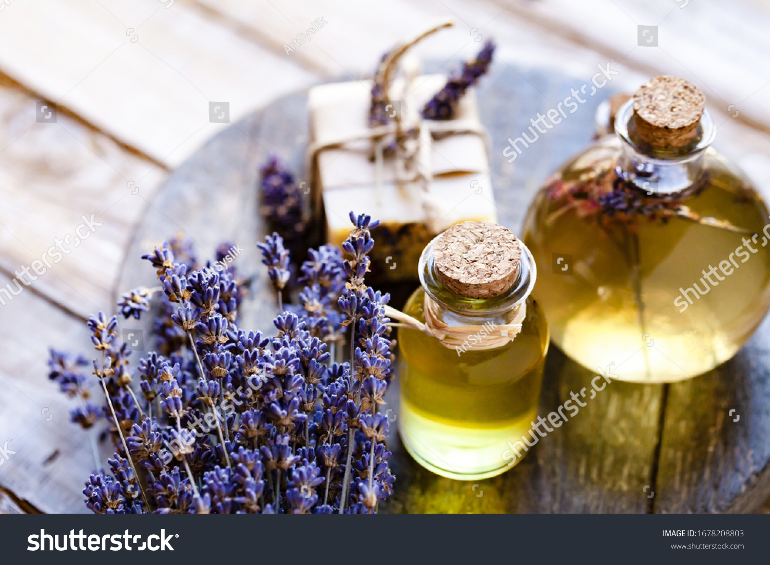 Concept of natural organic oil in cosmetology. Moisturizing skin care and aromatherapy. Gentle body treatment. Handmade soap. Atmosphere of harmony relax. Wooden background, lavender flower copy space #1678208803