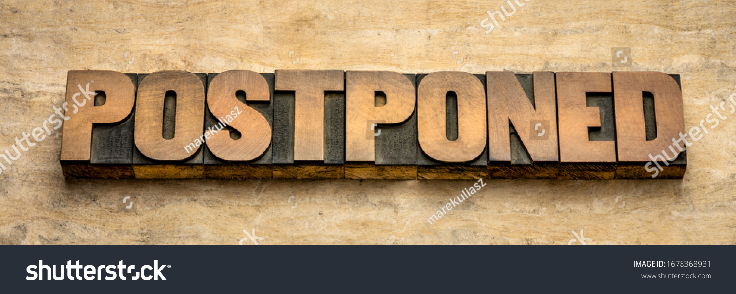 postponed  - word abstract in vintage letterpress wood type, event postponement due to covid-19 coronavirus pandemic, social distancing concept #1678368931