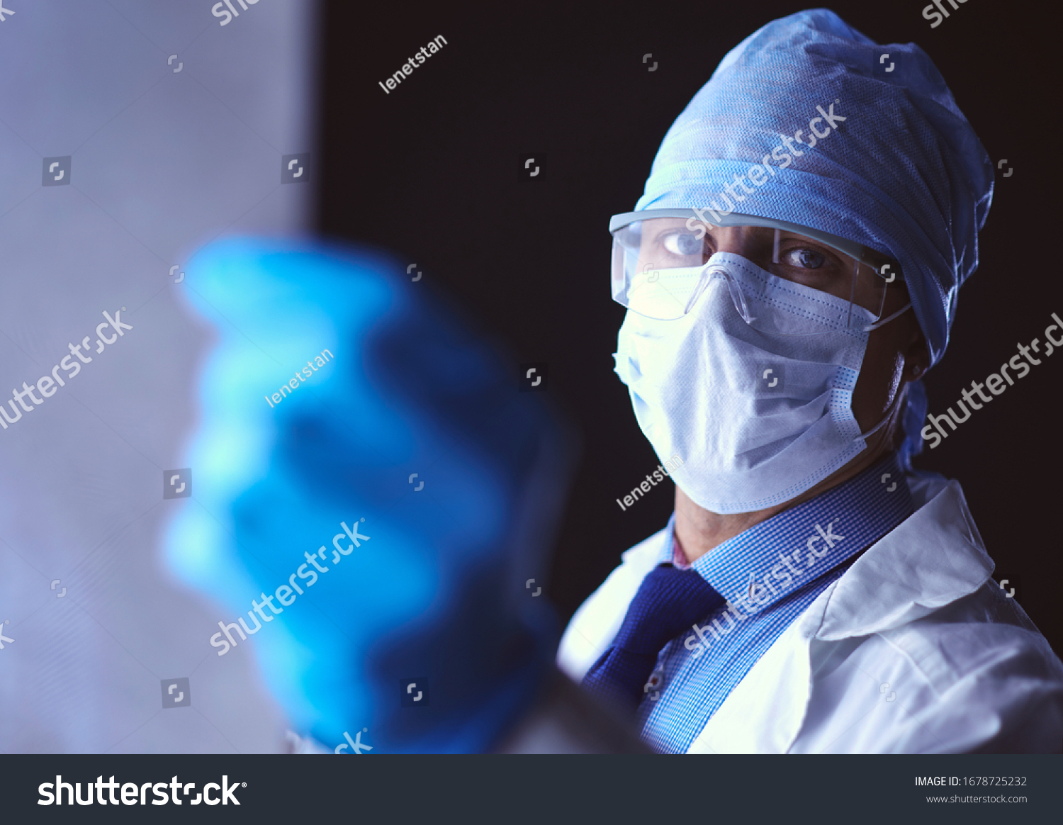 Young doctor looking X-Ray image on isolated white background #1678725232