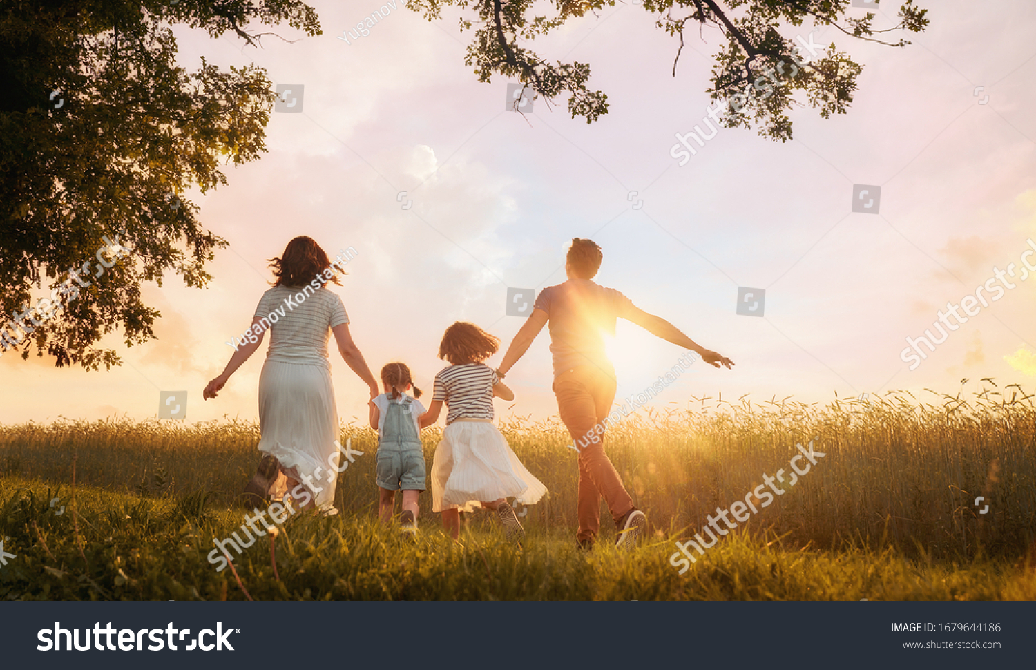 Happy family on summer walk! Mother, father and daughters walking in the Park and enjoying the beautiful nature. #1679644186