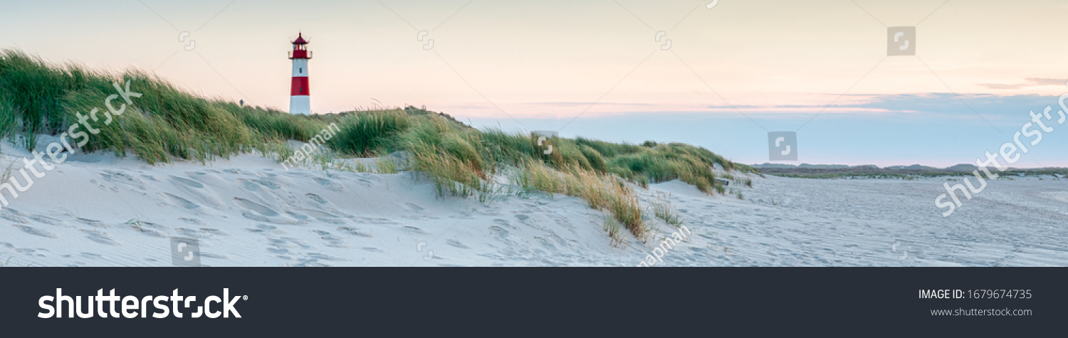 Panoramic view of a lighthouse standing at the coast of Sylt, North Sea, Germany #1679674735