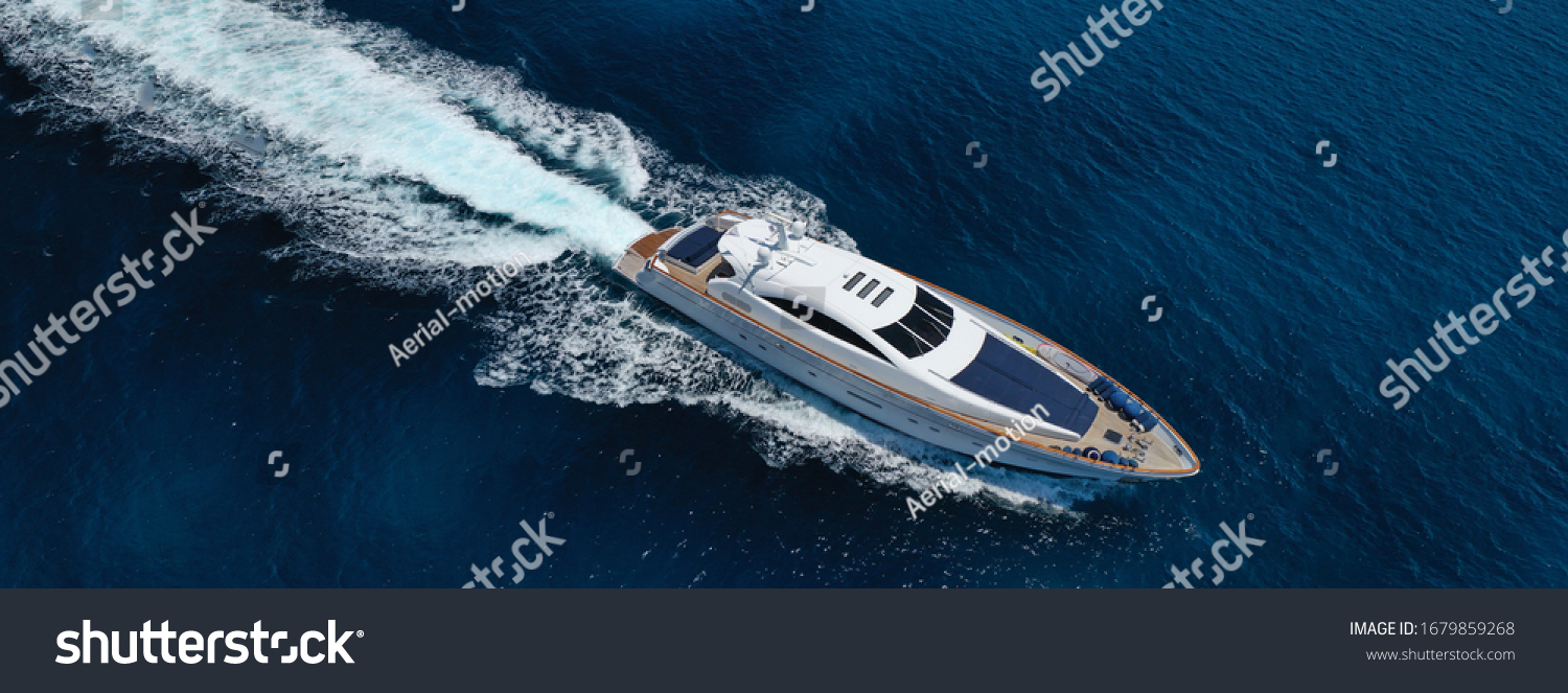 Aerial drone ultra wide photo of luxury yacht cruising in deep blue sea near Mediterranean Aegean island #1679859268