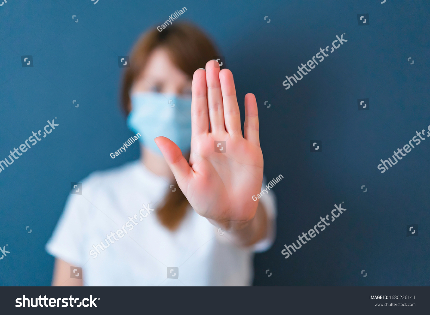 Coronavirus concept. Girl wearing mask for protection from disease and show stop hands gesture for stop corona virus outbreak. Global call to stay home #1680226144