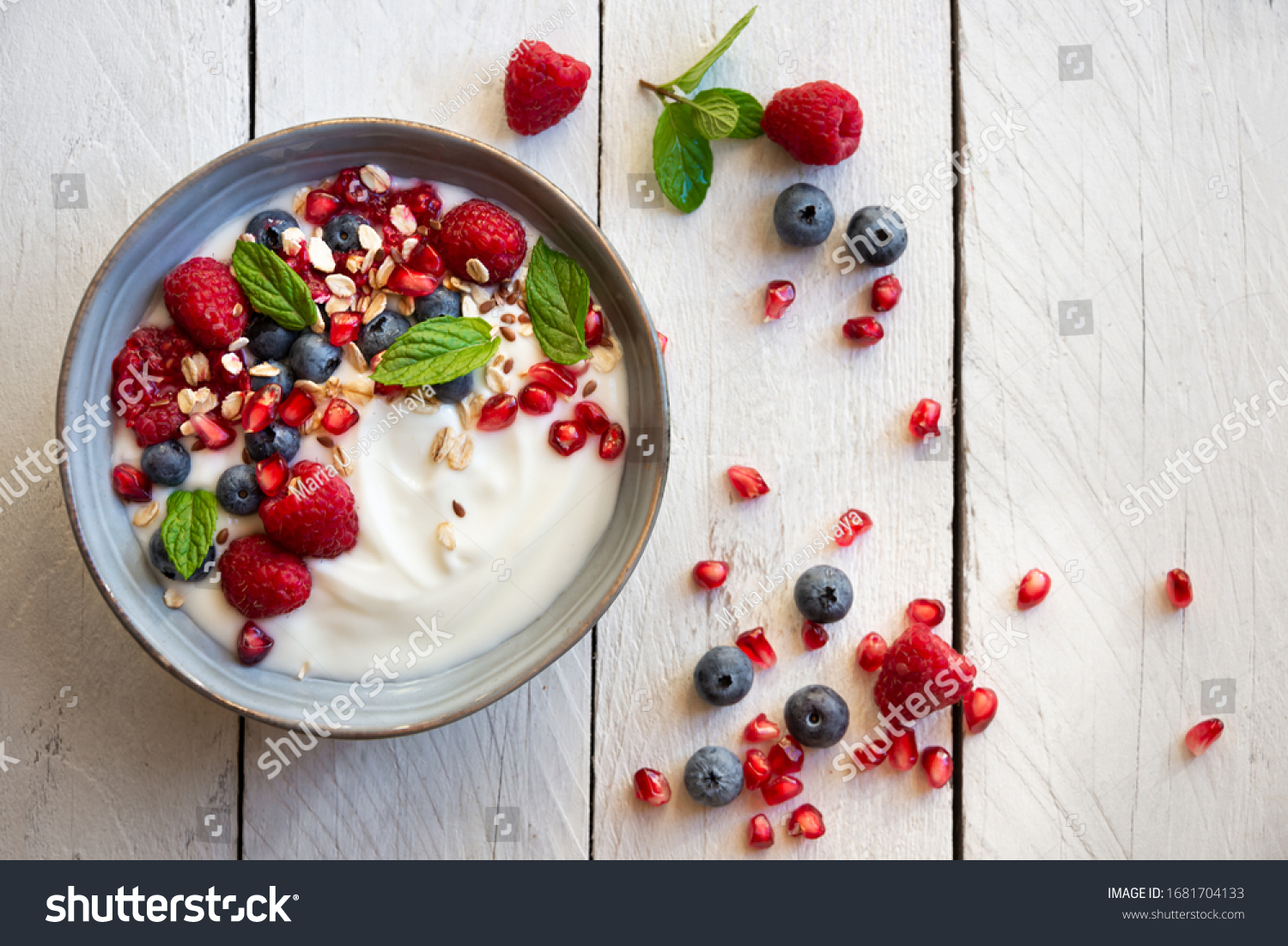 Yogurt with fresh fruit and berries (raspberry, pomegranate, blueberry) and mint for healthy breakfast #1681704133