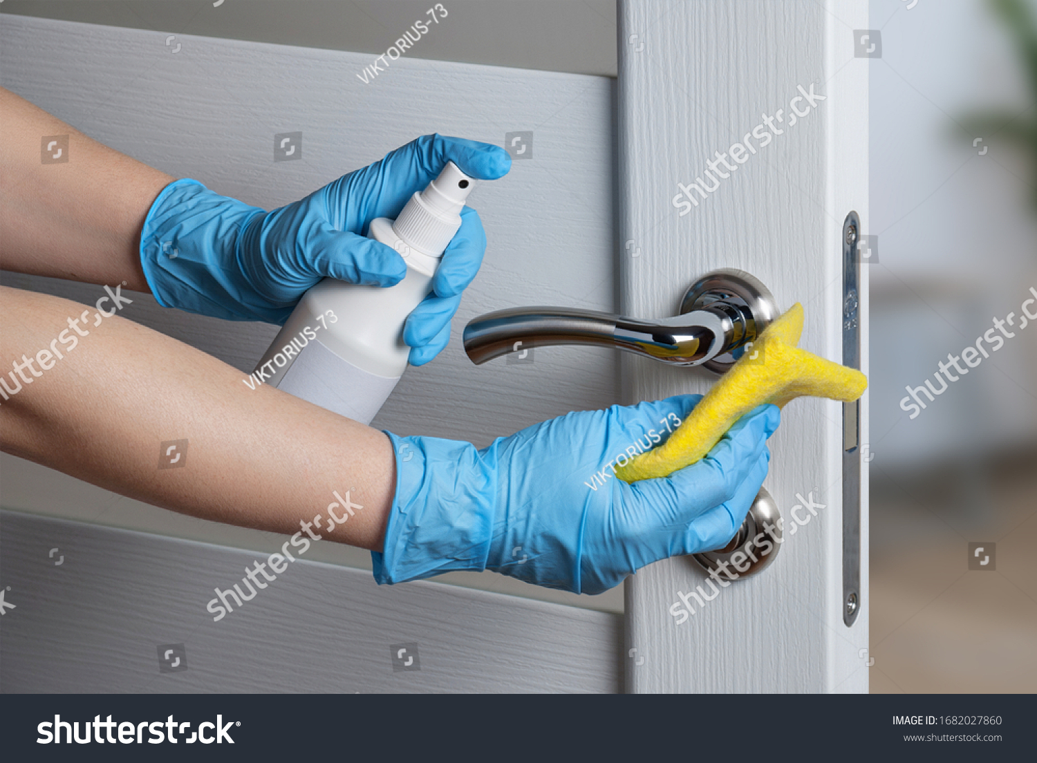 Cleaning door handles with an antiseptic during a viral epidemic