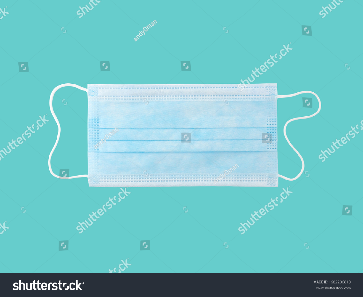 close up single light blue surgical mask (medical face mask) with white rope strap for prevent germs while performing surgery or protective coronavirus (COVID-19) outbreak isolated on cyan background #1682206810