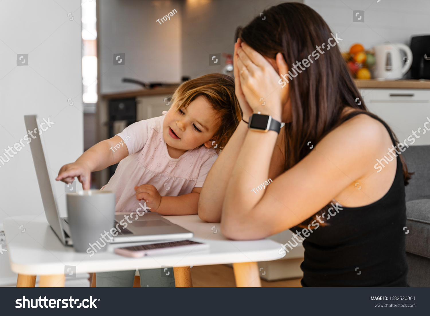 Mother working from home with baby toddler. Crying child and stressed woman. Stay home #1682520004