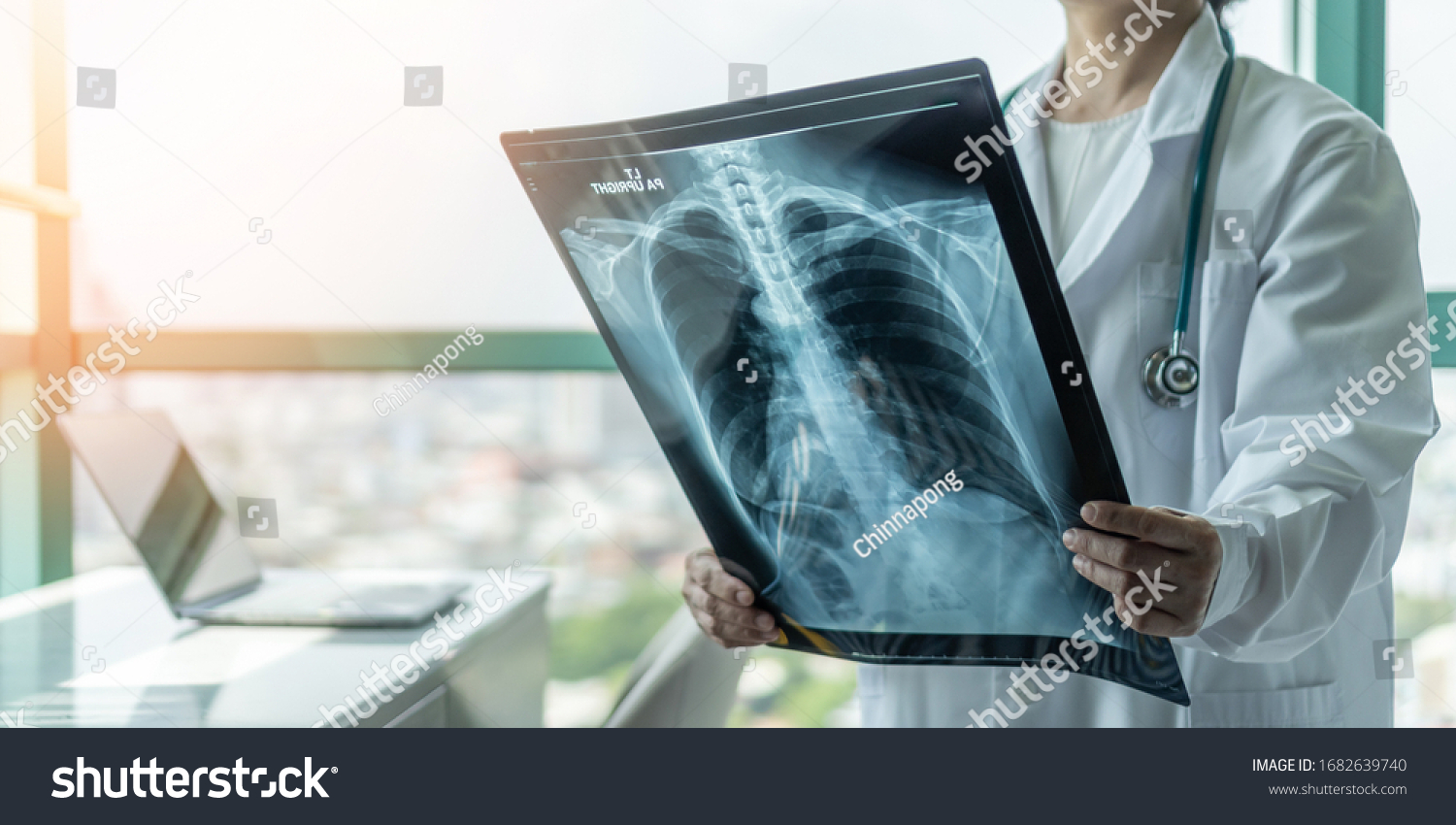 Doctor diagnosing patient’s health on asthma, lung disease, COVID-19, coronavirus or bone cancer illness with radiological chest x-ray film for medical healthcare hospital service #1682639740