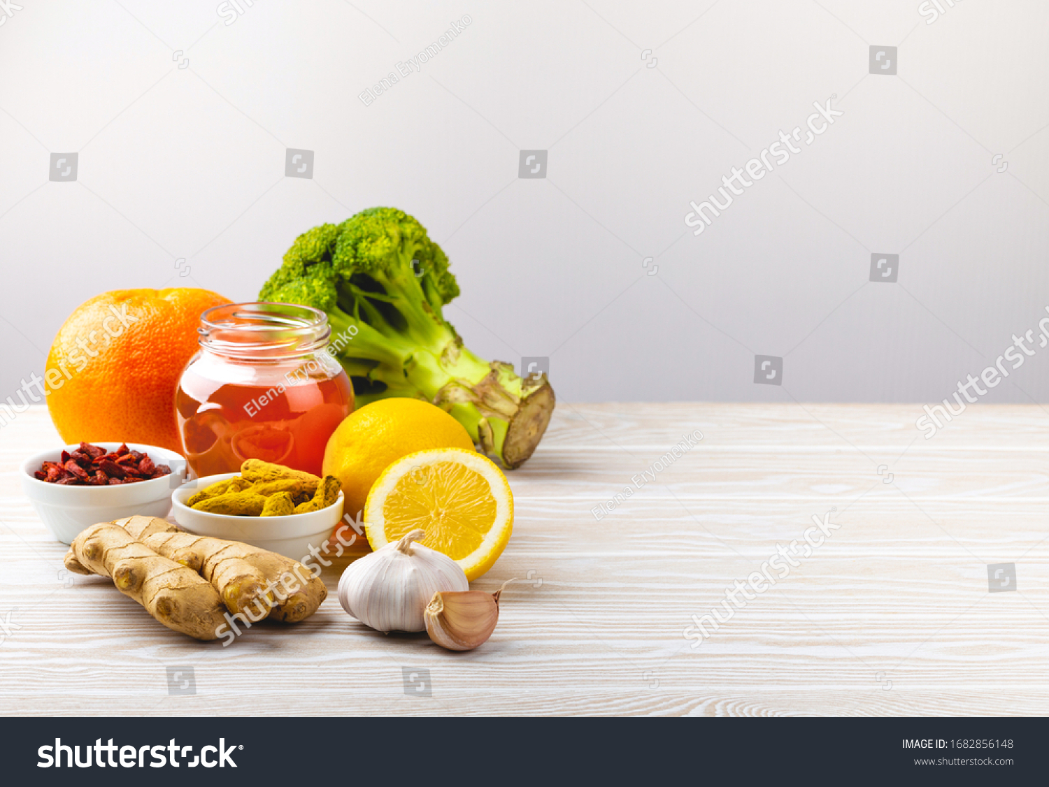 Food for immunity stimulation and viruses protection. Broccoli, citrus fruits, honey, ginger, lemon, garlic, goji, turmeric on white wooden background, copy space. Healthy food to boost immune system
 #1682856148