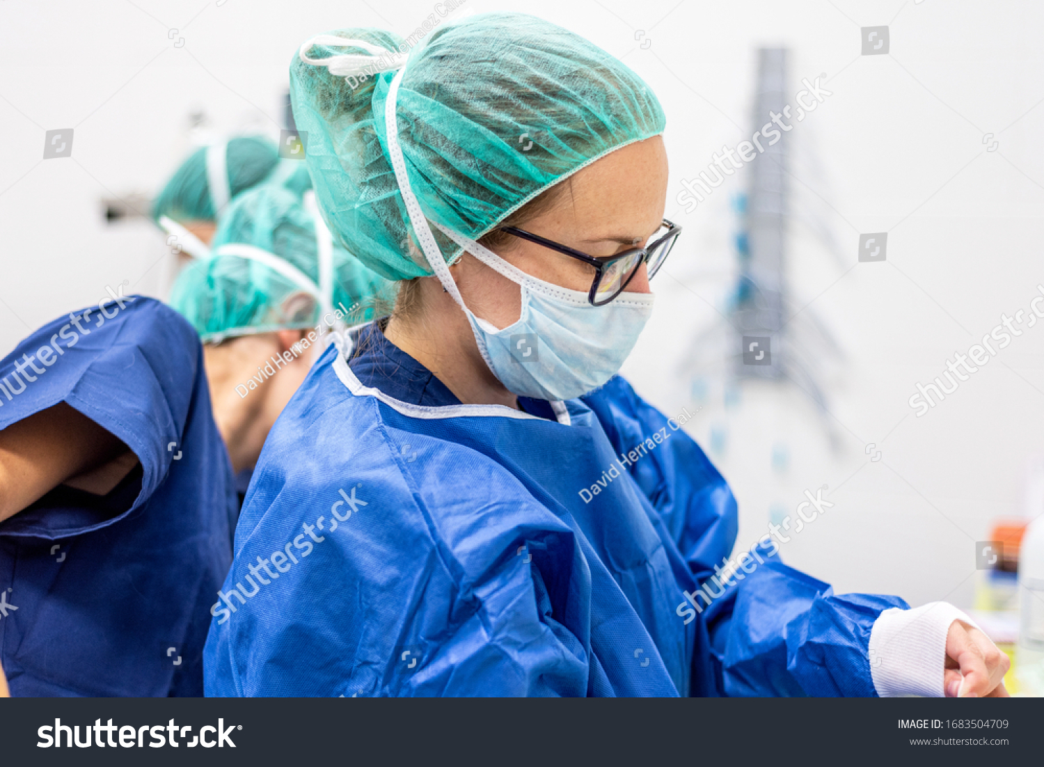 Covid-19. Female nurse puts on protective gloves. Personal protective equipment in the fight against Coronavirus disease . #1683504709