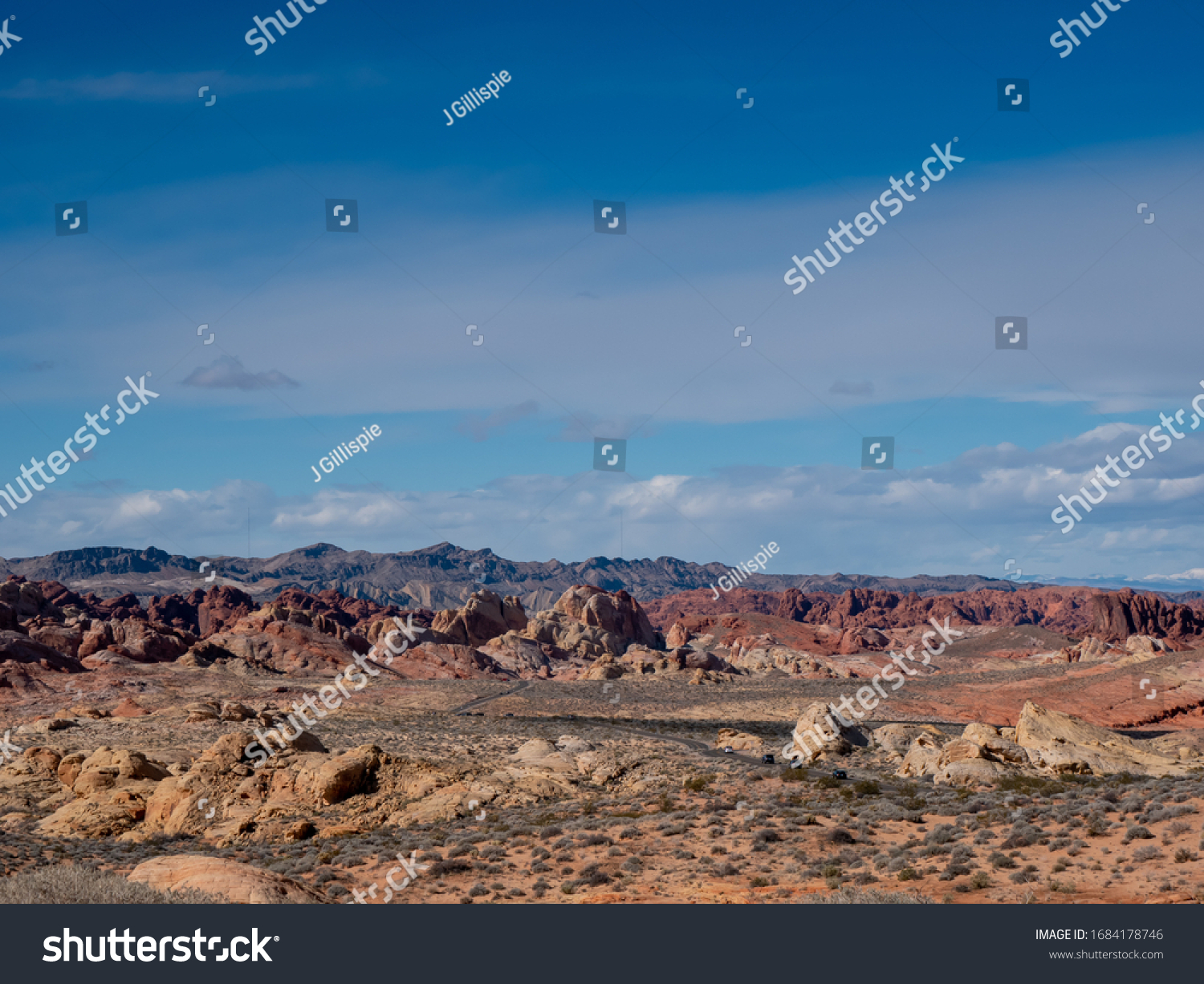 Blue sky over a road through beautiful rugged desert terrain at Valley of Fire State Park, Nevada, USA #1684178746