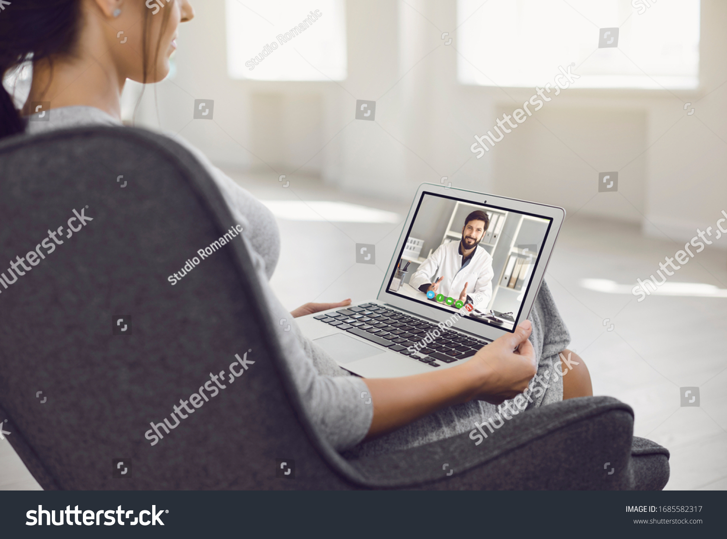 Online doctor.A sick young woman video chat with a male doctor at home. #1685582317