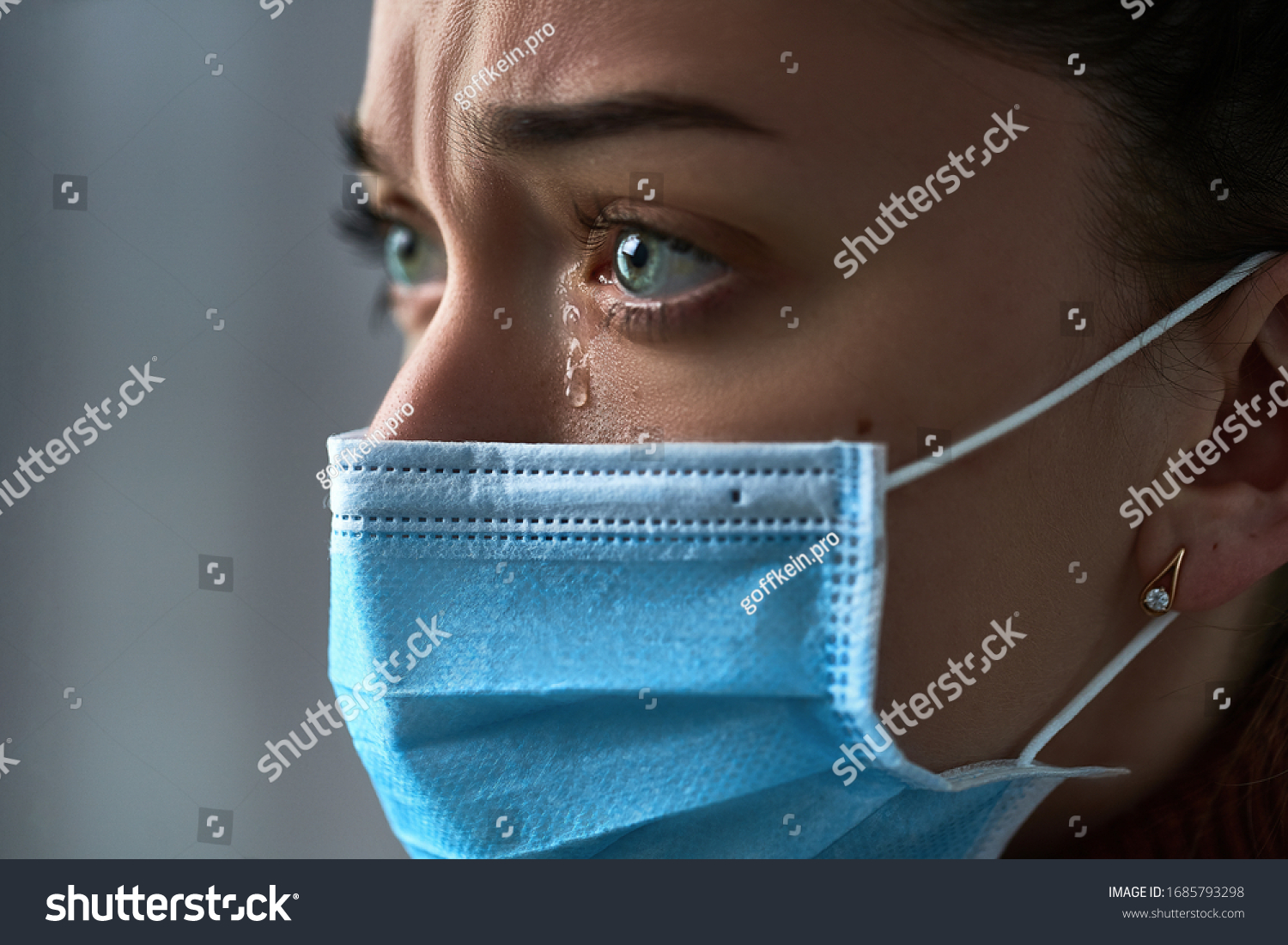 Upset depressed melancholy sad crying woman in protective face mask with tears eyes during serious illness, coronavirus outbreak and flu covid-19 epidemic. Health problems difficulties #1685793298