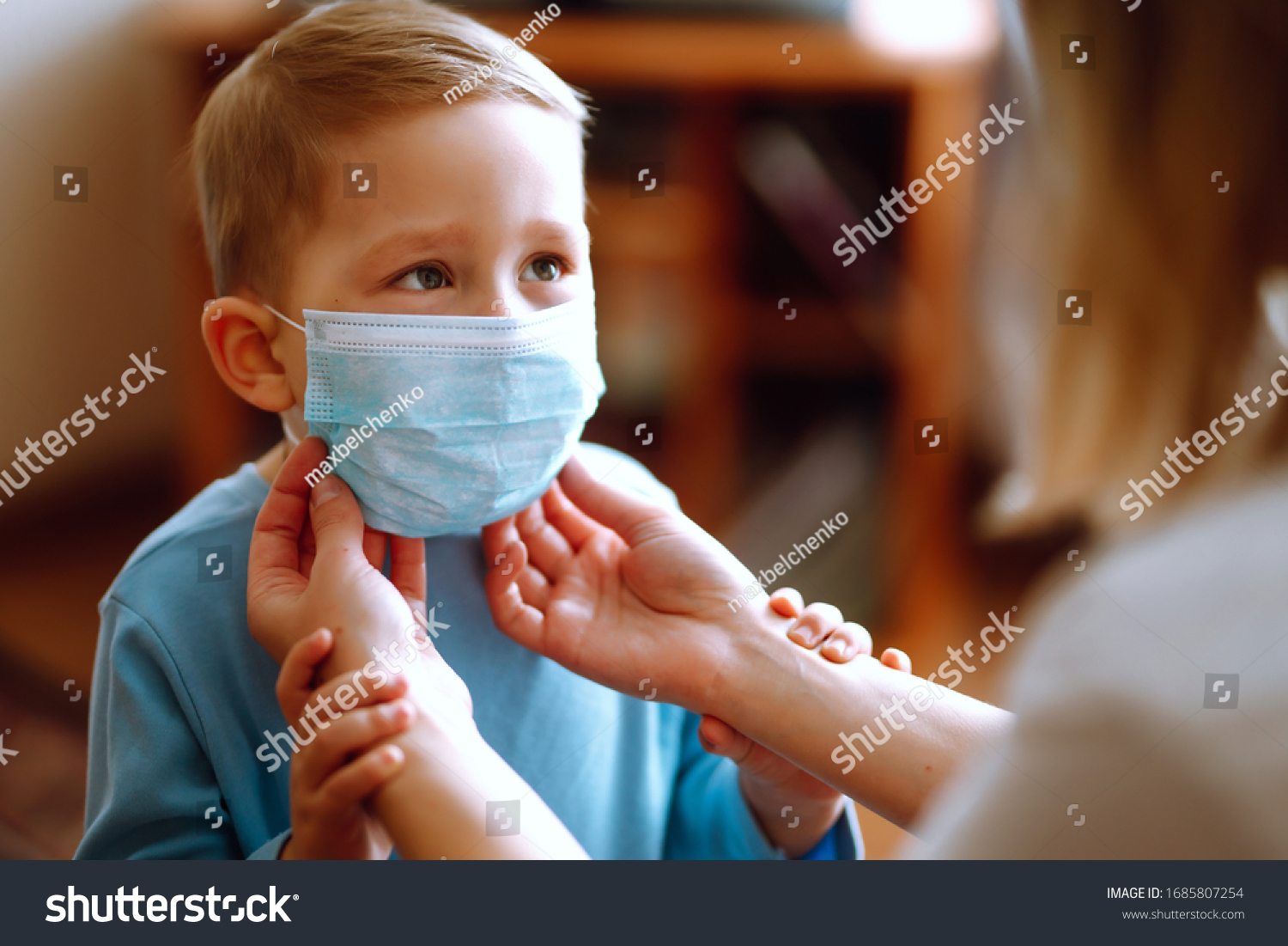Little boy and mom in medical mask. Mother puts on her baby sterile medical mask. Child, wearing face mask, protect from infection of virus, pandemic, outbreak and epidemic of disease on quarantine. #1685807254