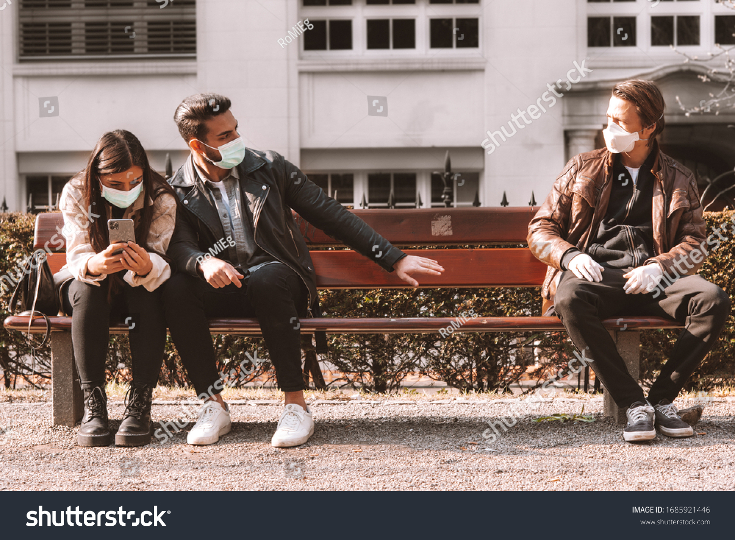 corona covid-19 social distancing concept picture with three people wearing face masks - stay away #1685921446