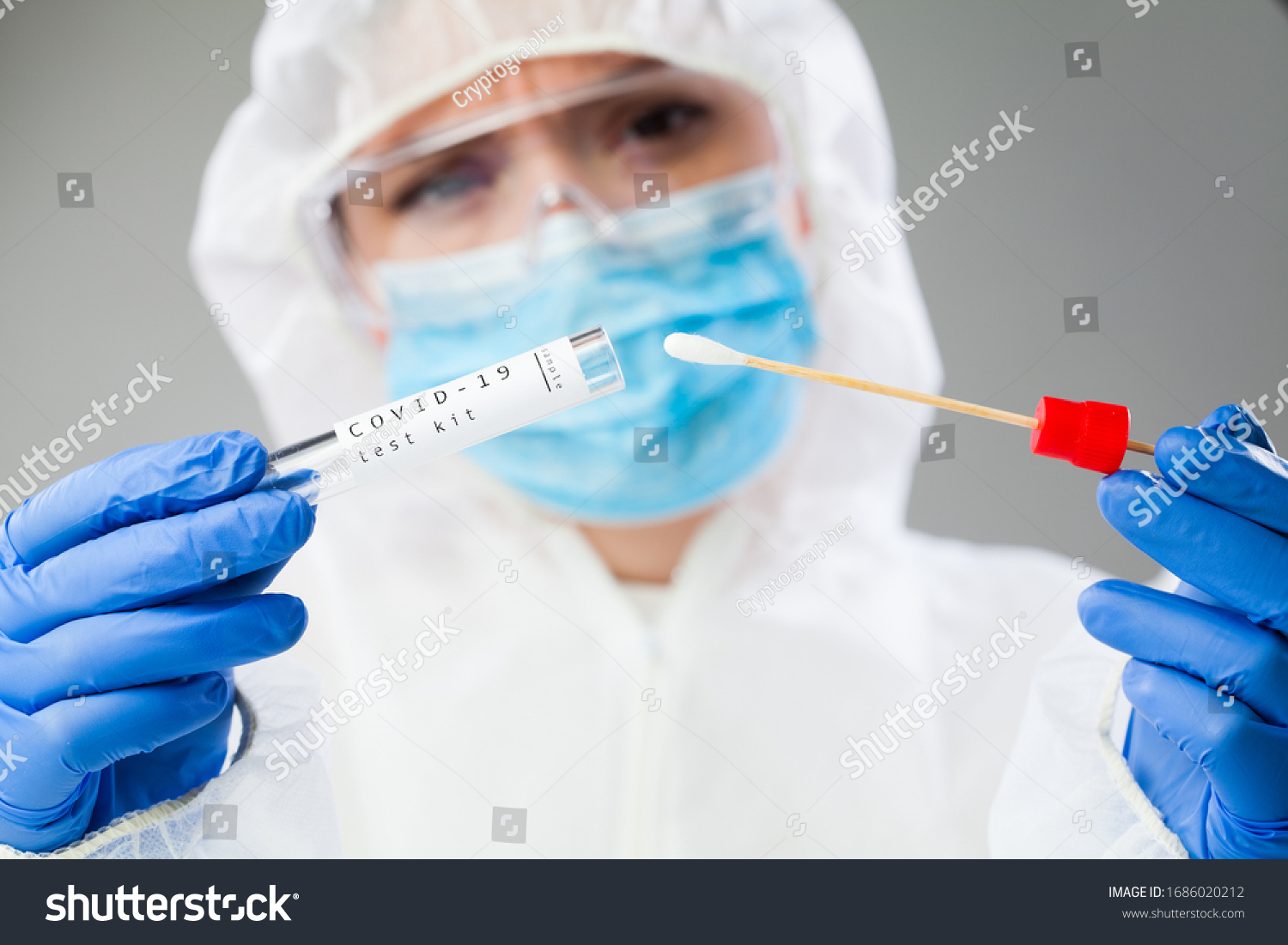Medical healthcare NHS technician holding COVID-19 swab collection kit,wearing white PPE protective suit mask gloves,test tube for taking OP NP patient specimen sample,PCR DNA testing protocol process #1686020212