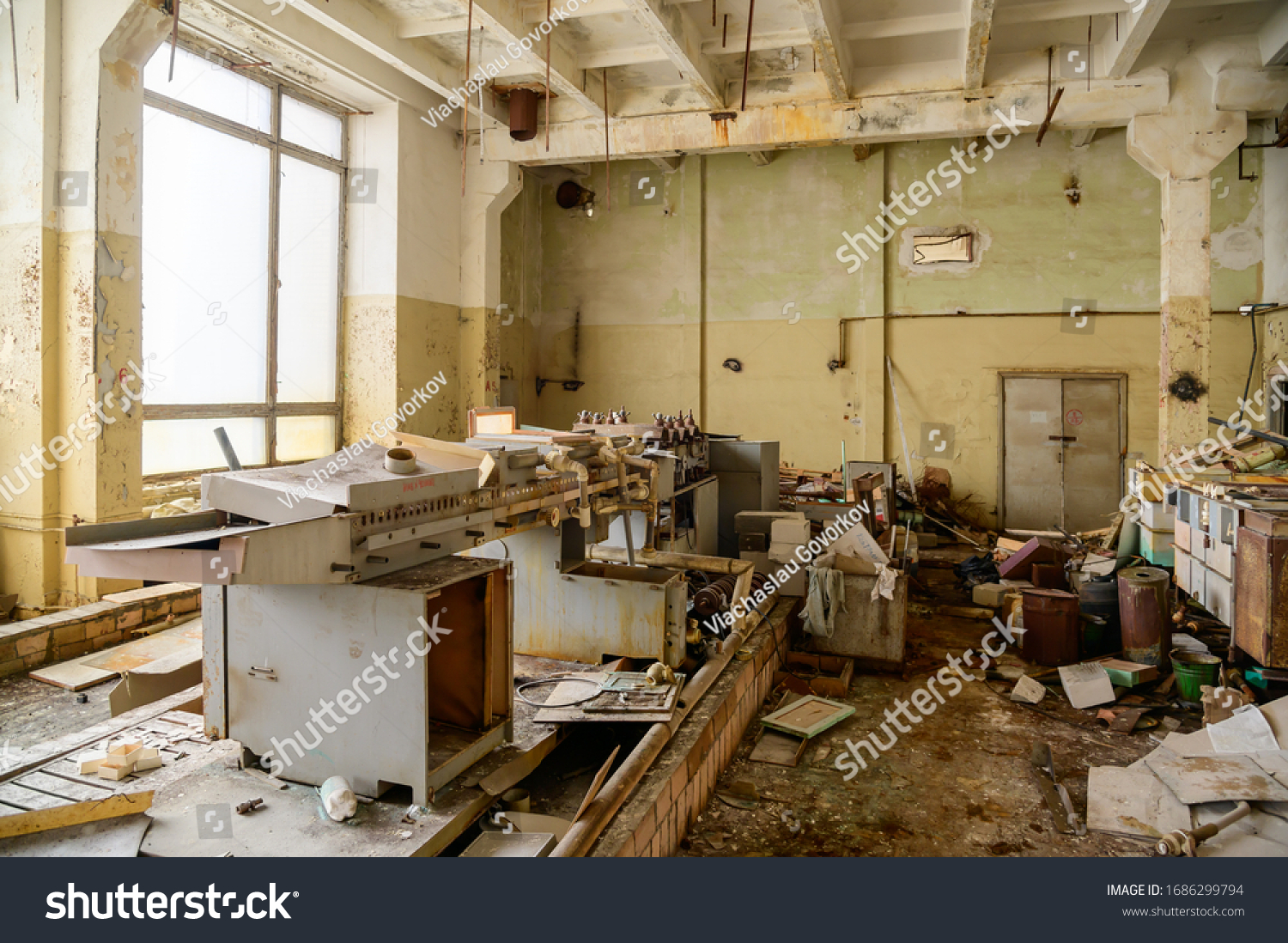 Photo of a garbage dump in an abandoned room of a destroyed factory #1686299794