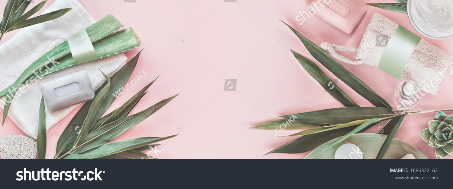 Modern skin care beauty and cosmetics concept with products bottles with mock up, aloe vera and palm leaves on pastel pink background. Natural cosmetic. Banner. Top view. Eco friendly. Zero waste. #1686322162