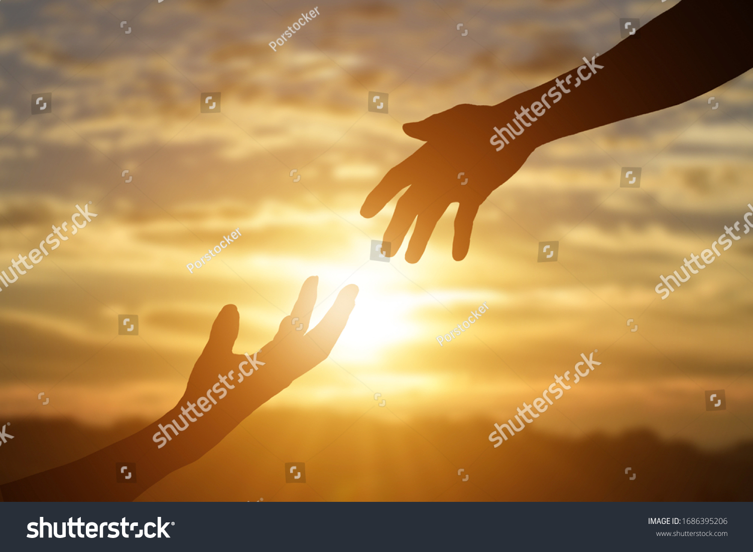 Silhouette of reaching, giving a helping hand, hope and support each other over sunset background.  #1686395206
